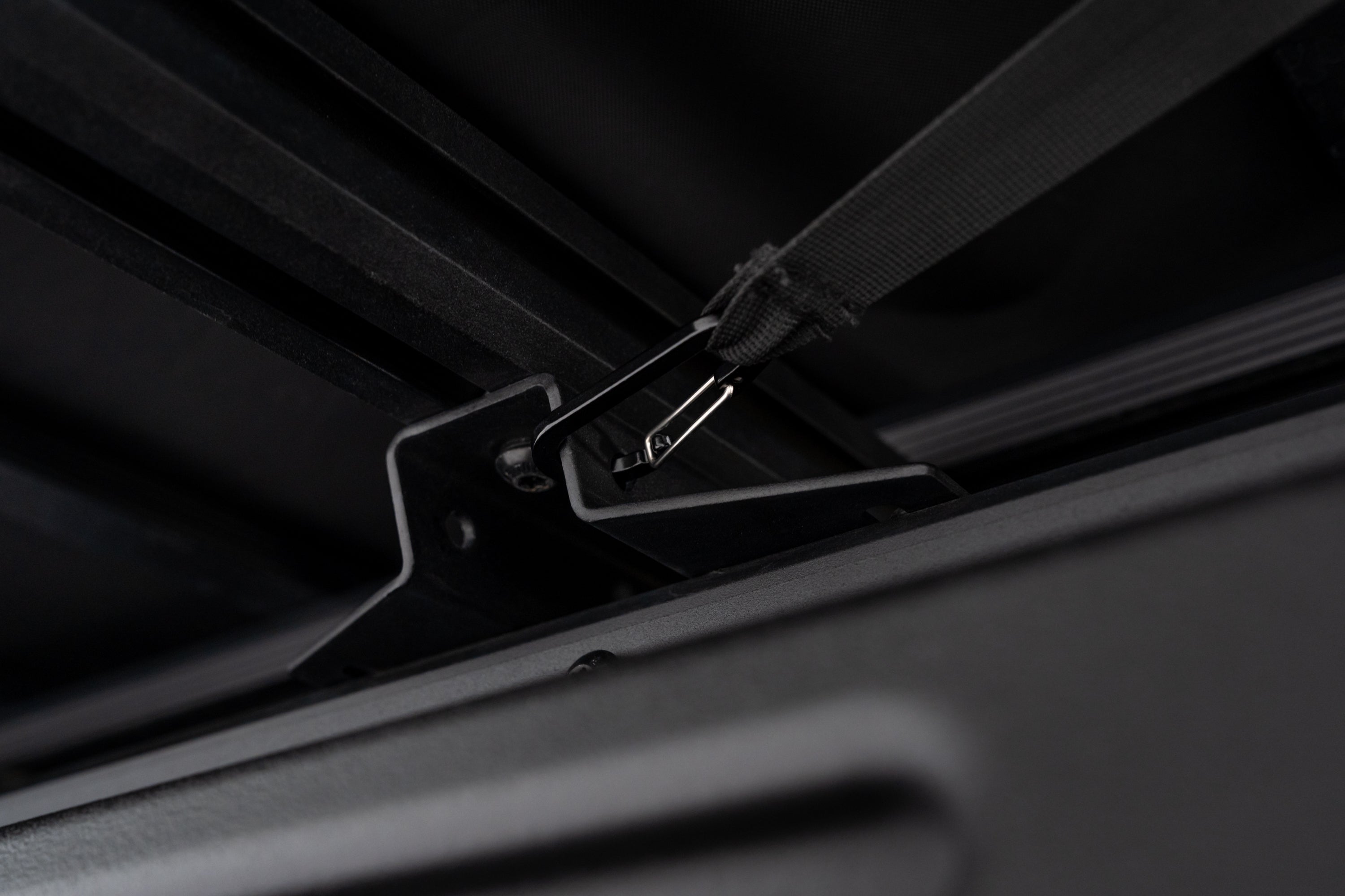 Up close photo of the carabiner attachment point on the 270 V2 Awning by FSR secured to the roof rack.
