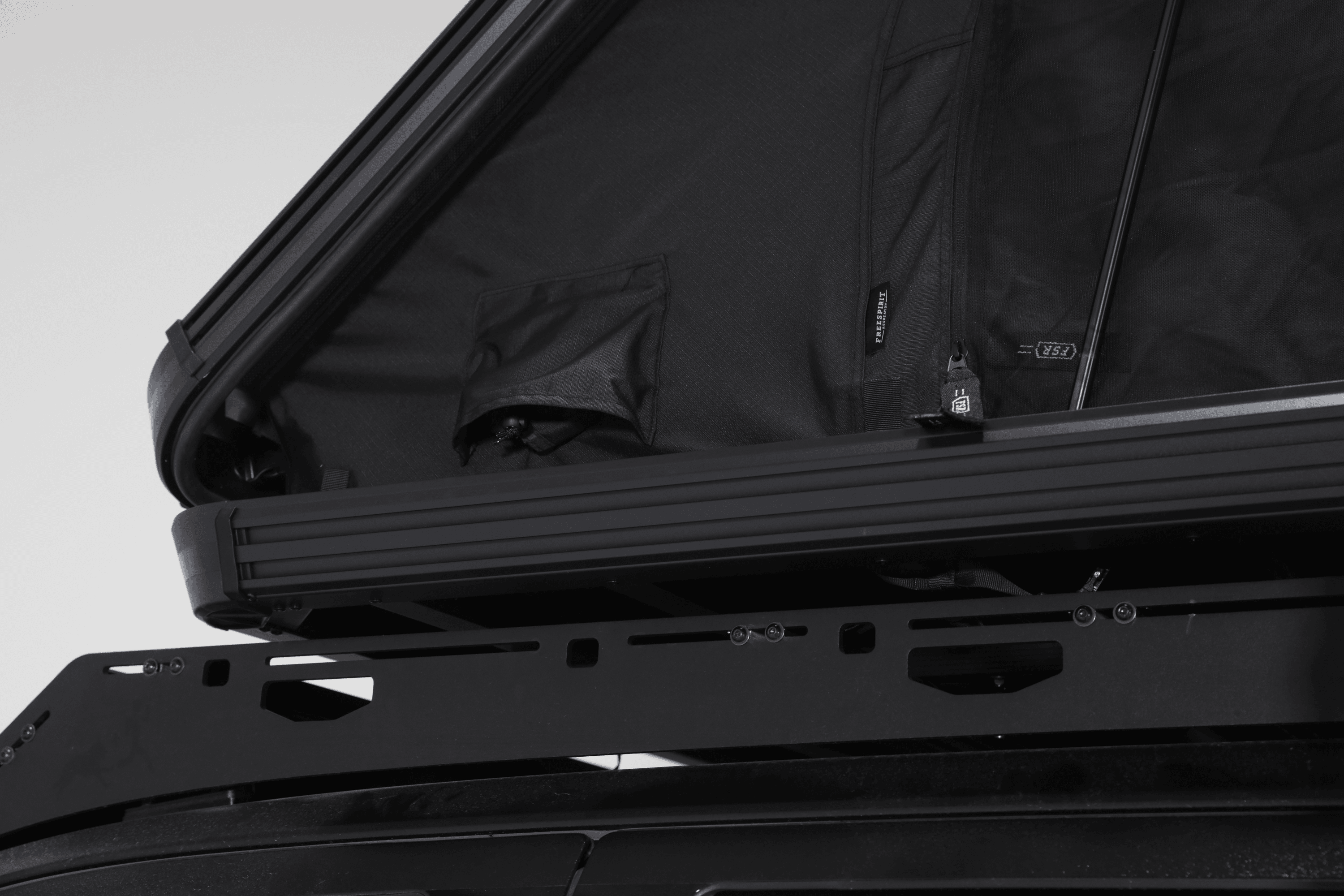 Side profile, close up photo of a deployed FSR Aspen V2 standard rooftop tent diesel heater port.