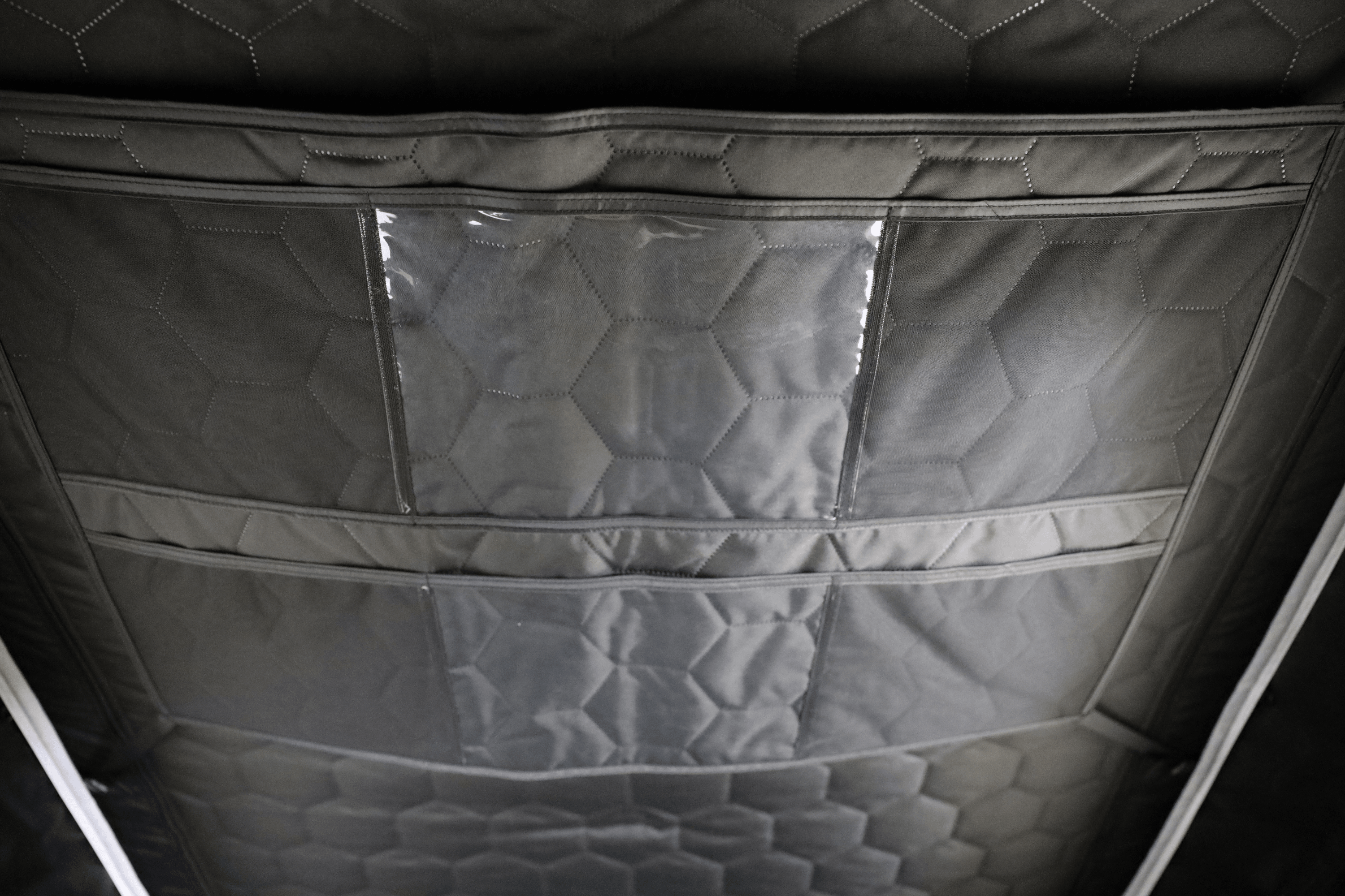 Interior, close up photo of a deployed FSR Aspen V2 standard rooftop tent gear grid.
