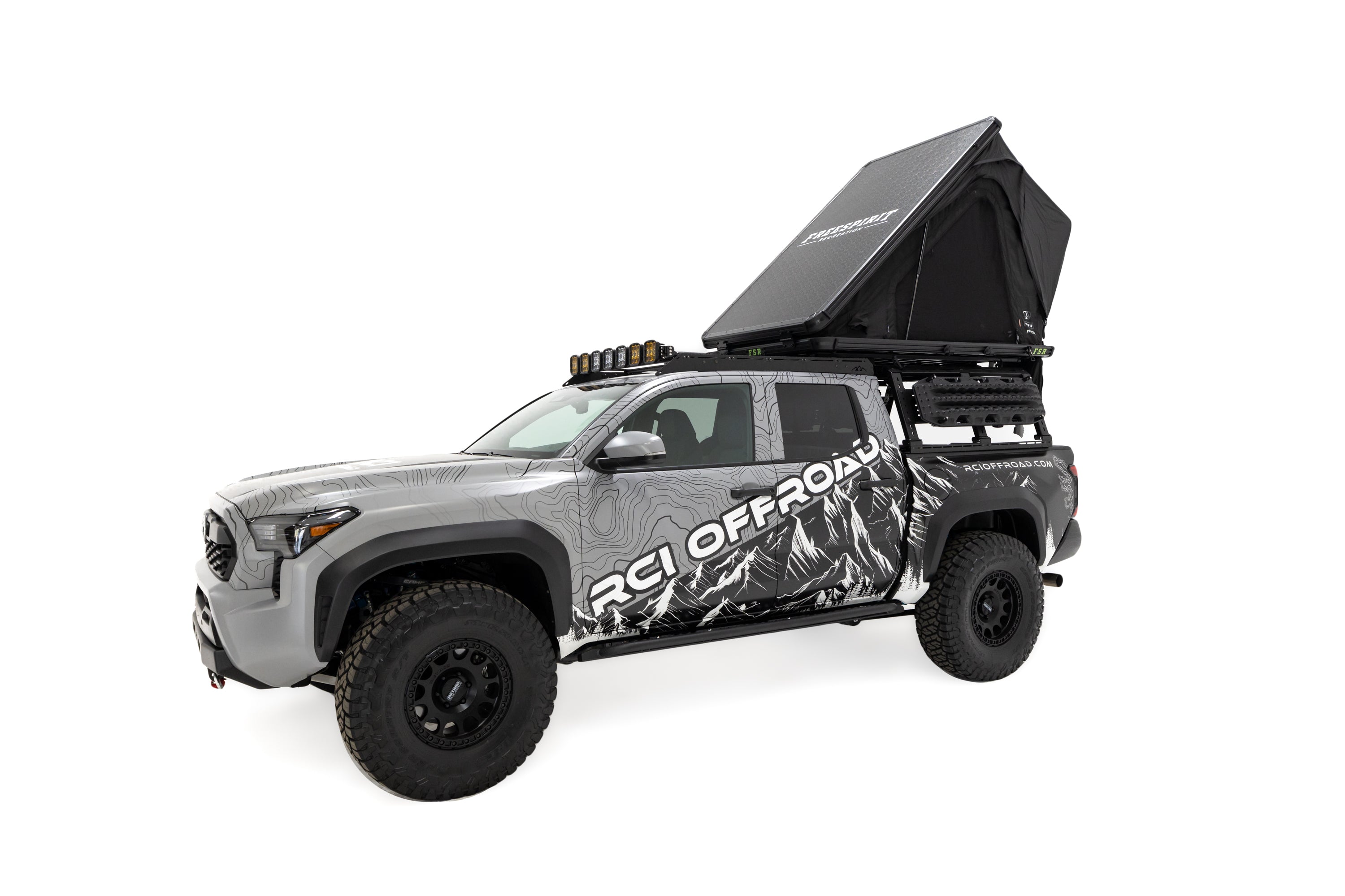 Front angle photo of RCI Toyota Tacoma with FSR Aspen V2 standard rooftop tent mounted on the bed of the short bed pickup.