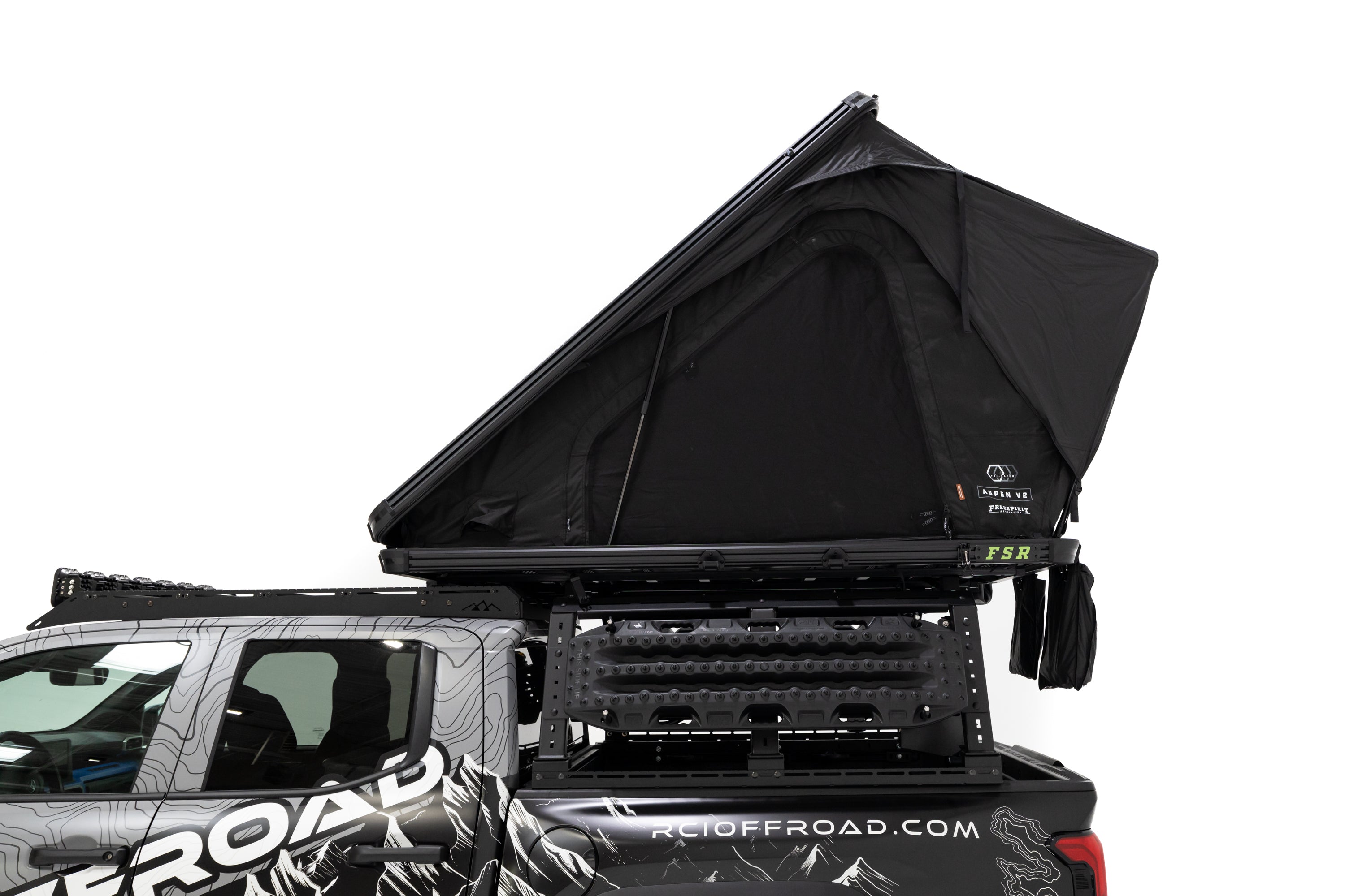 Side profile, close up photo of RCI Toyota Tacoma with a deployed FSR Aspen V2 standard rooftop tent mounted on the bed of the short bed pickup.