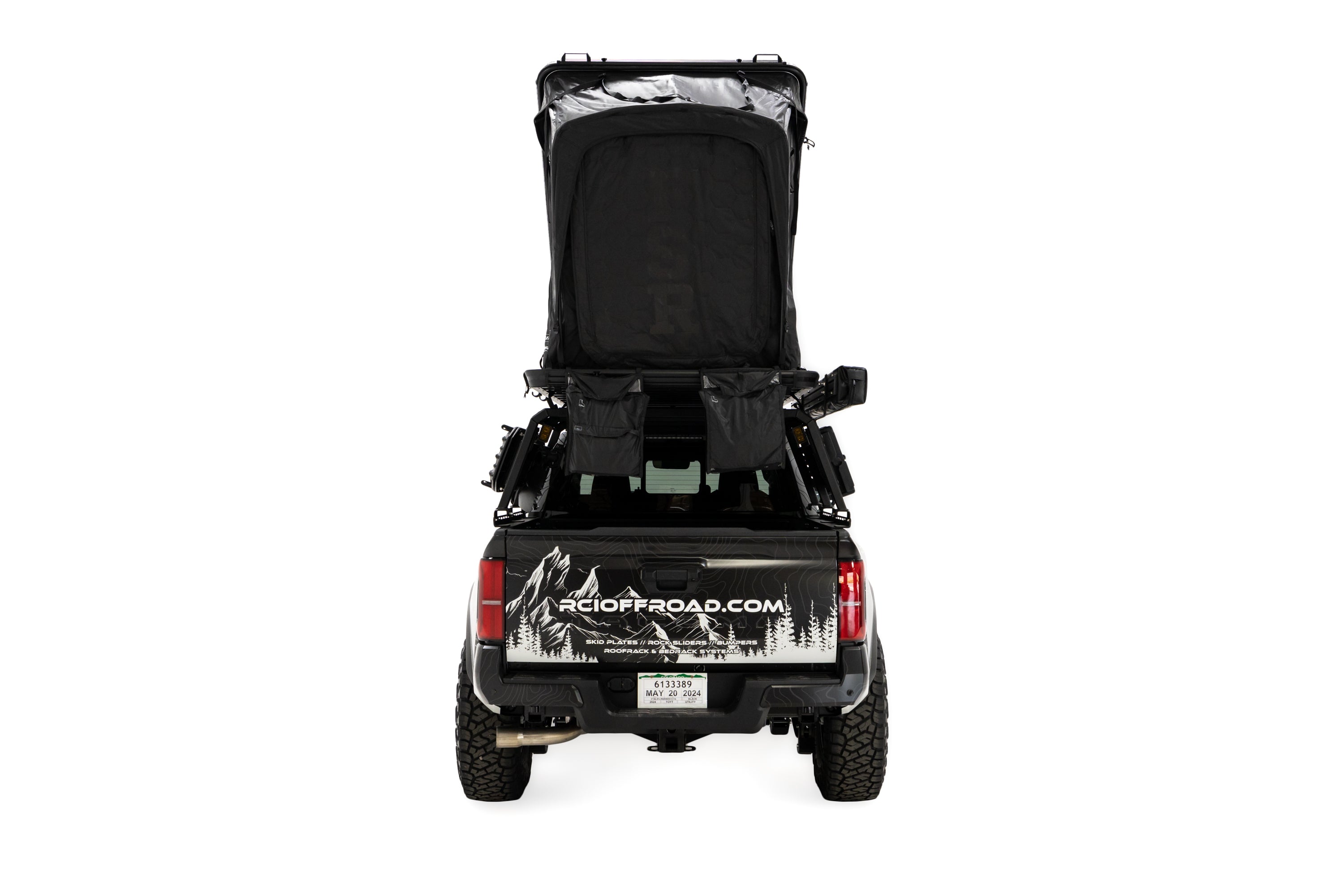 Rear photo of RCI Toyota Tacoma with a deployed FSR Aspen V2 standard rooftop tent mounted on the bed of the short bed pickup.