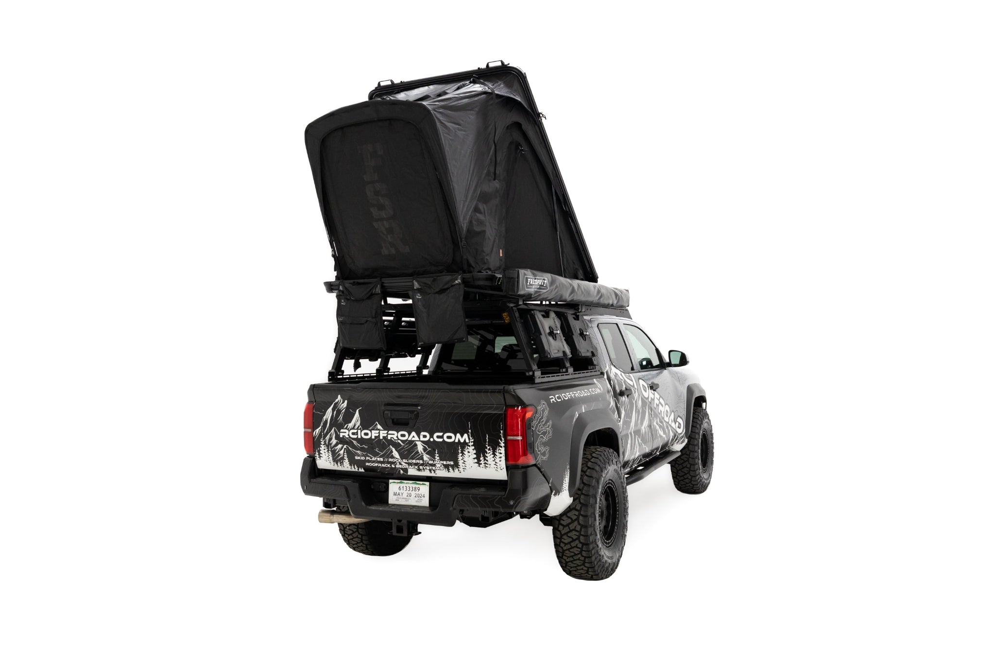 Rear passenger angle, close up photo of RCI Toyota Tacoma with a deployed FSR Aspen V2 standard rooftop tent mounted on the bed of the short bed pickup.