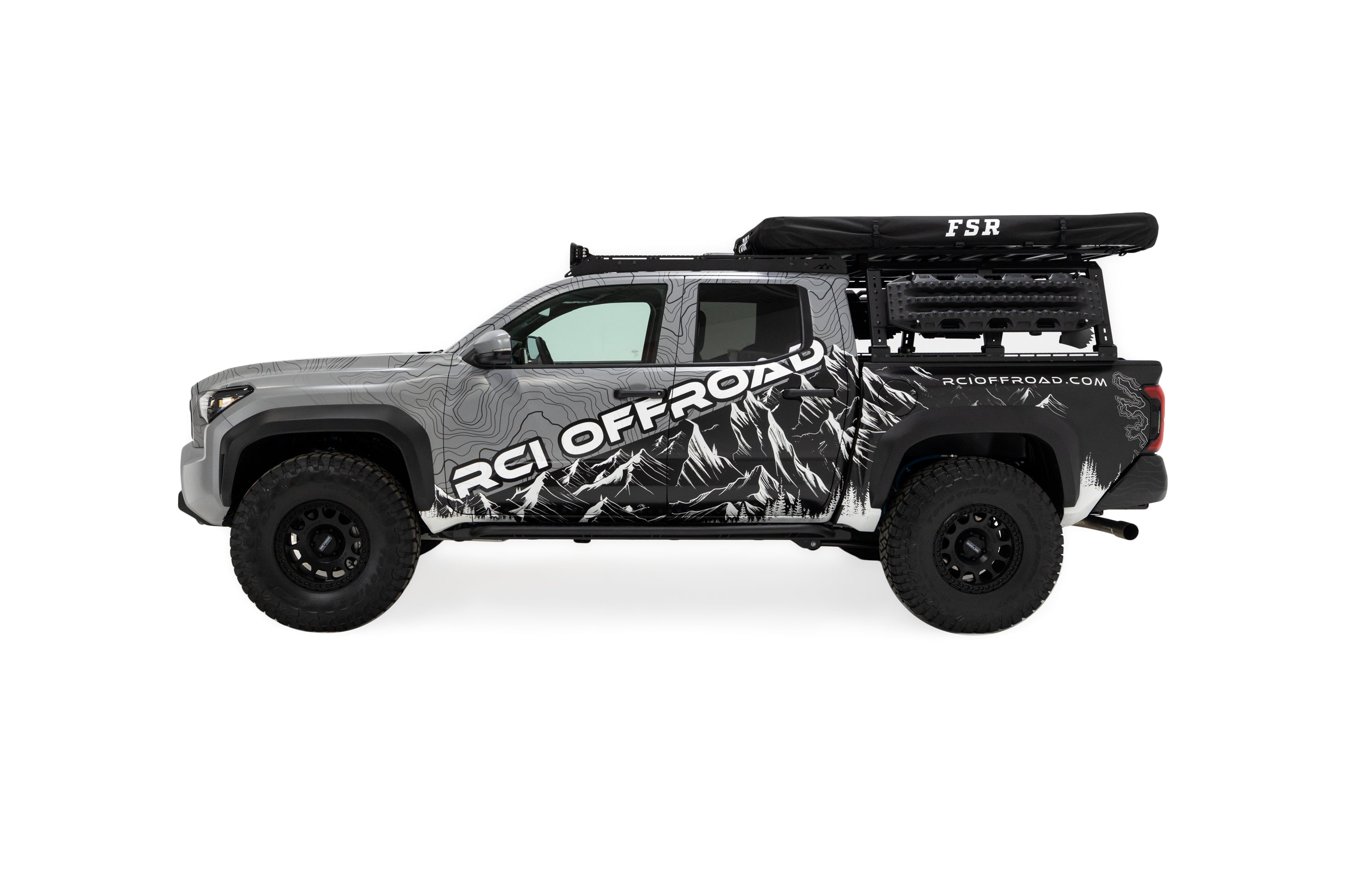 Side profile photo of RCI Toyota Tacoma with FSR Aspen V2 standard rooftop tent mounted on the bed of the short bed pickup with the cover on.