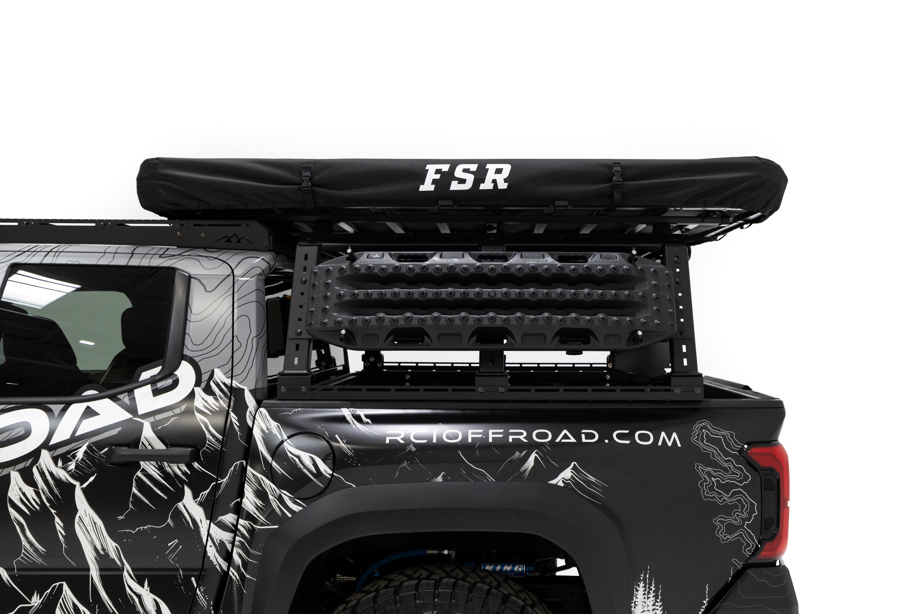 Close up side profile photo of RCI Toyota Tacoma with FSR Aspen V2 standard rooftop tent mounted on the bed of the short bed pickup with the tent cover on.
