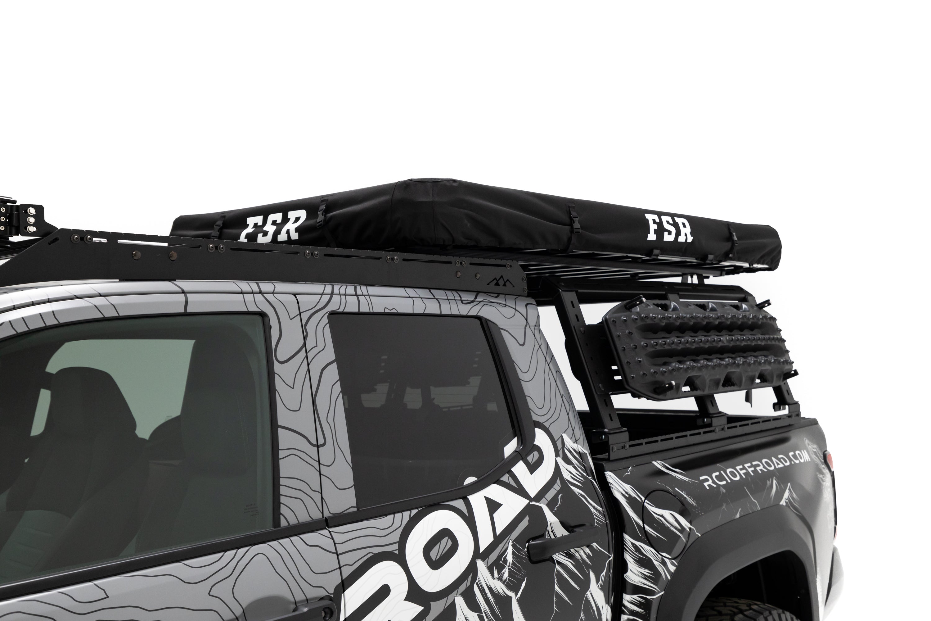 Front angle close up photo of RCI Toyota Tacoma with FSR Aspen V2 standard rooftop tent mounted on the bed of the short bed pickup with the cover on.