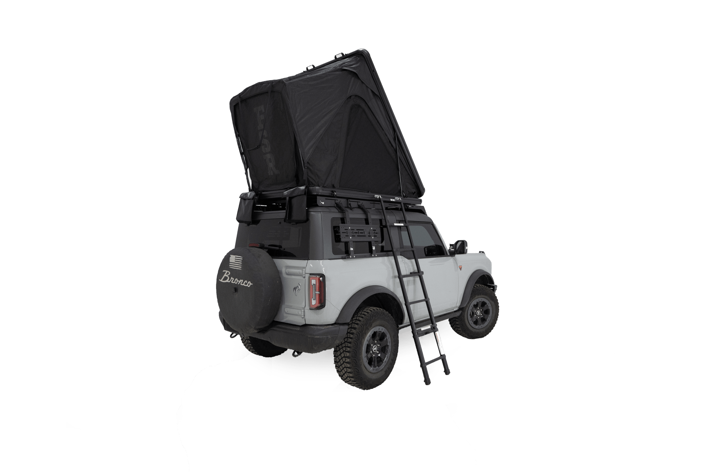 Exterior photo of the Aspen Lite Standard - Rooftop Tent by Freespirit Recreation mounted on a 2-door Ford Bronco in its deployed position.