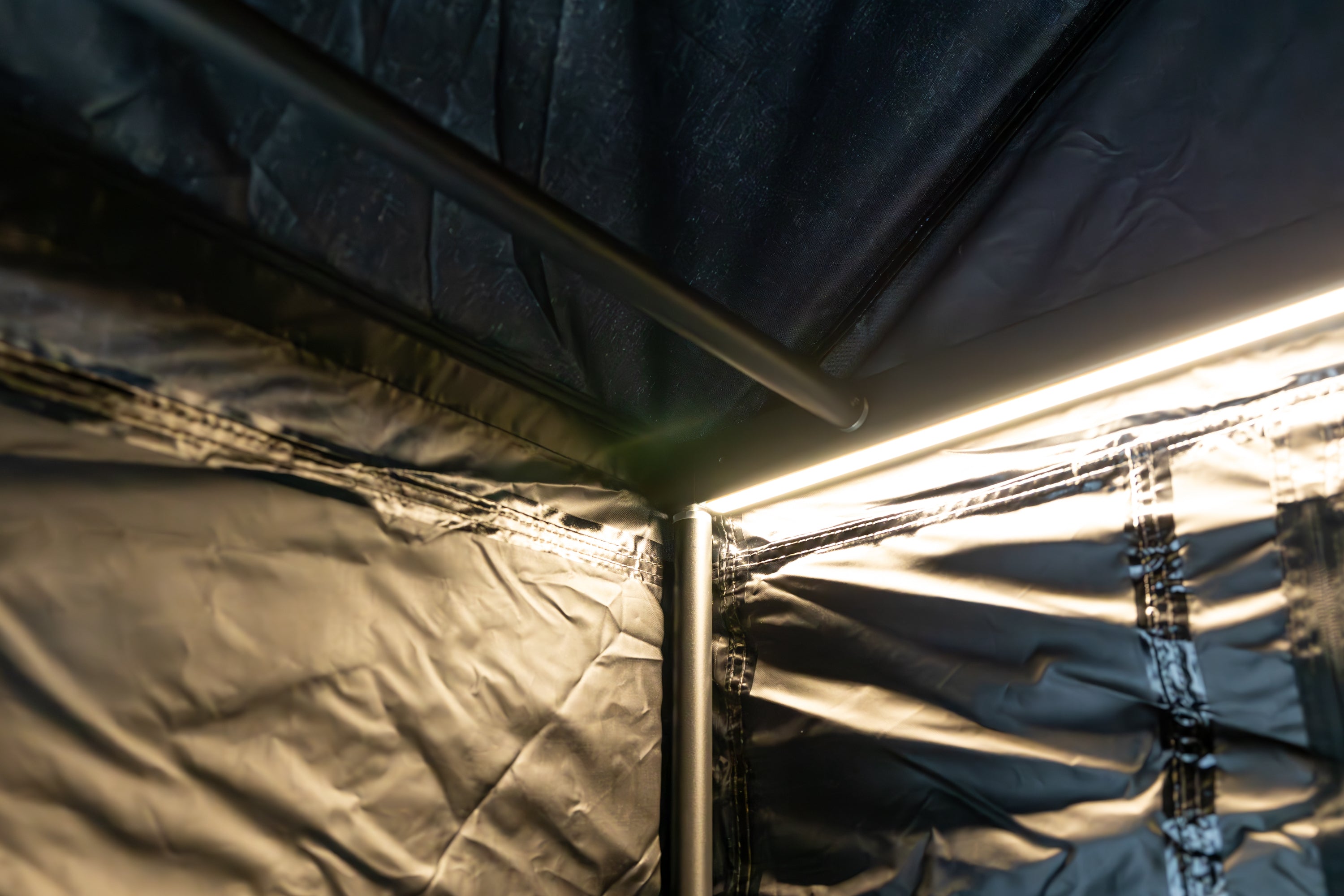 Interior photo of the interior arm of Awn-X Annex room displaying the support poles and LED light.
