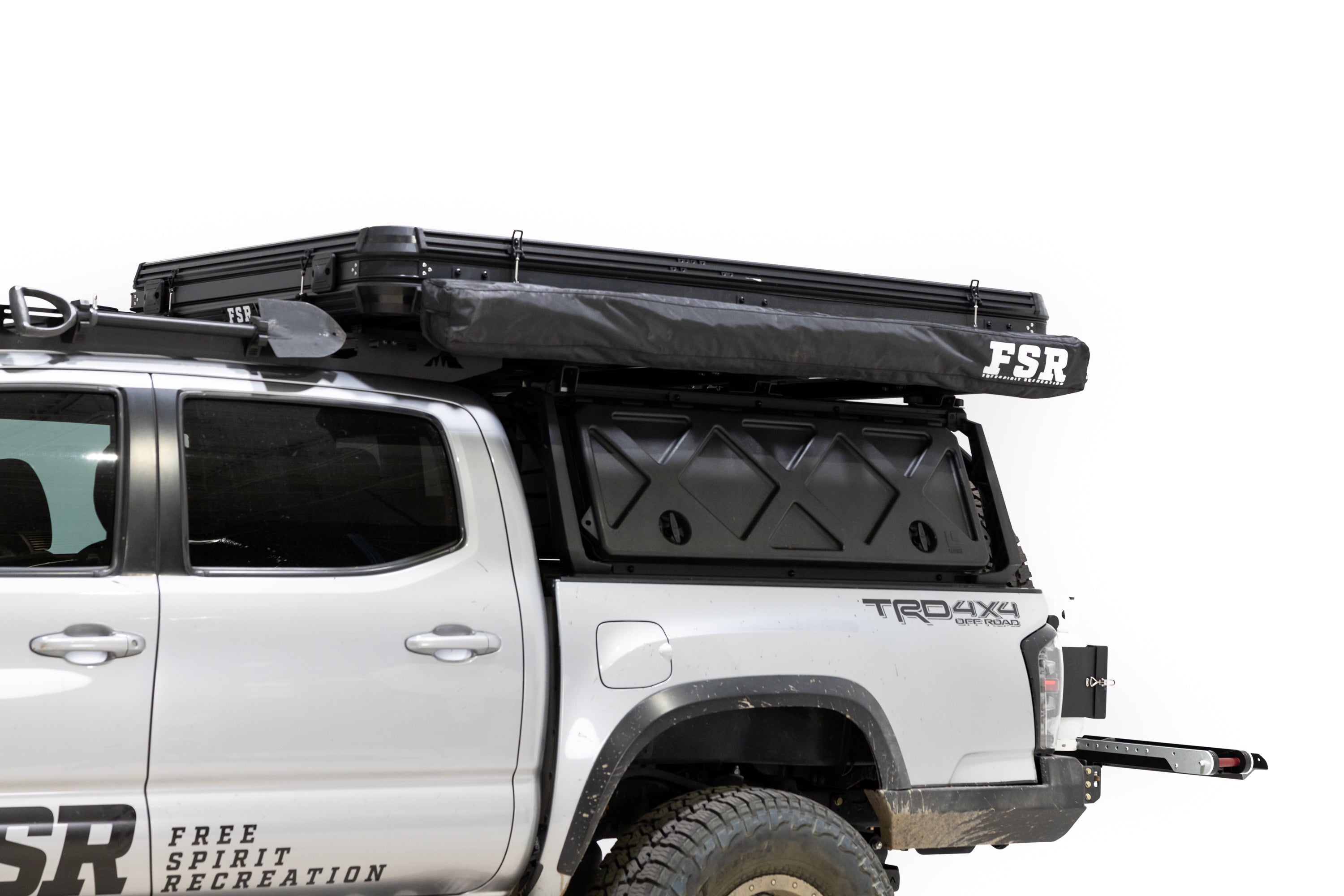 Up close exterior photo of Awn-X annex room stored away and closed on the side of the Evolution roof top tent mounted on a Toyota Tacoma.