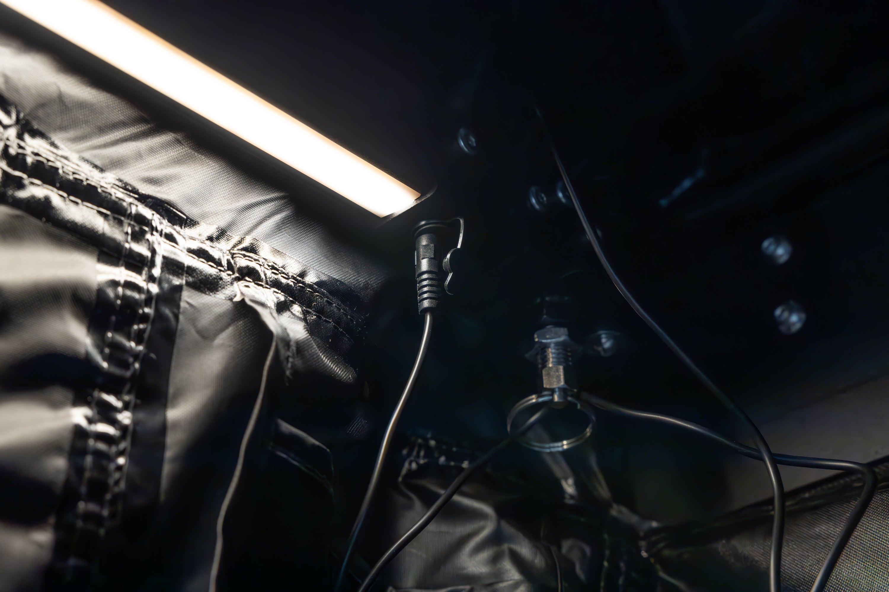 Picture of Awn-X Annex room interior arm light plug in close detail at lowest dimmable brightness.