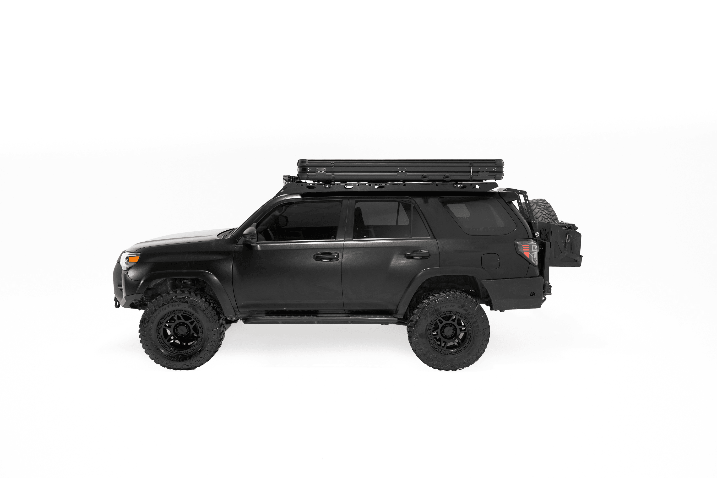 Side profile photo of a closed Evolution V2 Standard - Rooftop Tent by Freespirit Recreation displayed in a white cyc photo cyclorama on top of a black Toyota 4Runner.