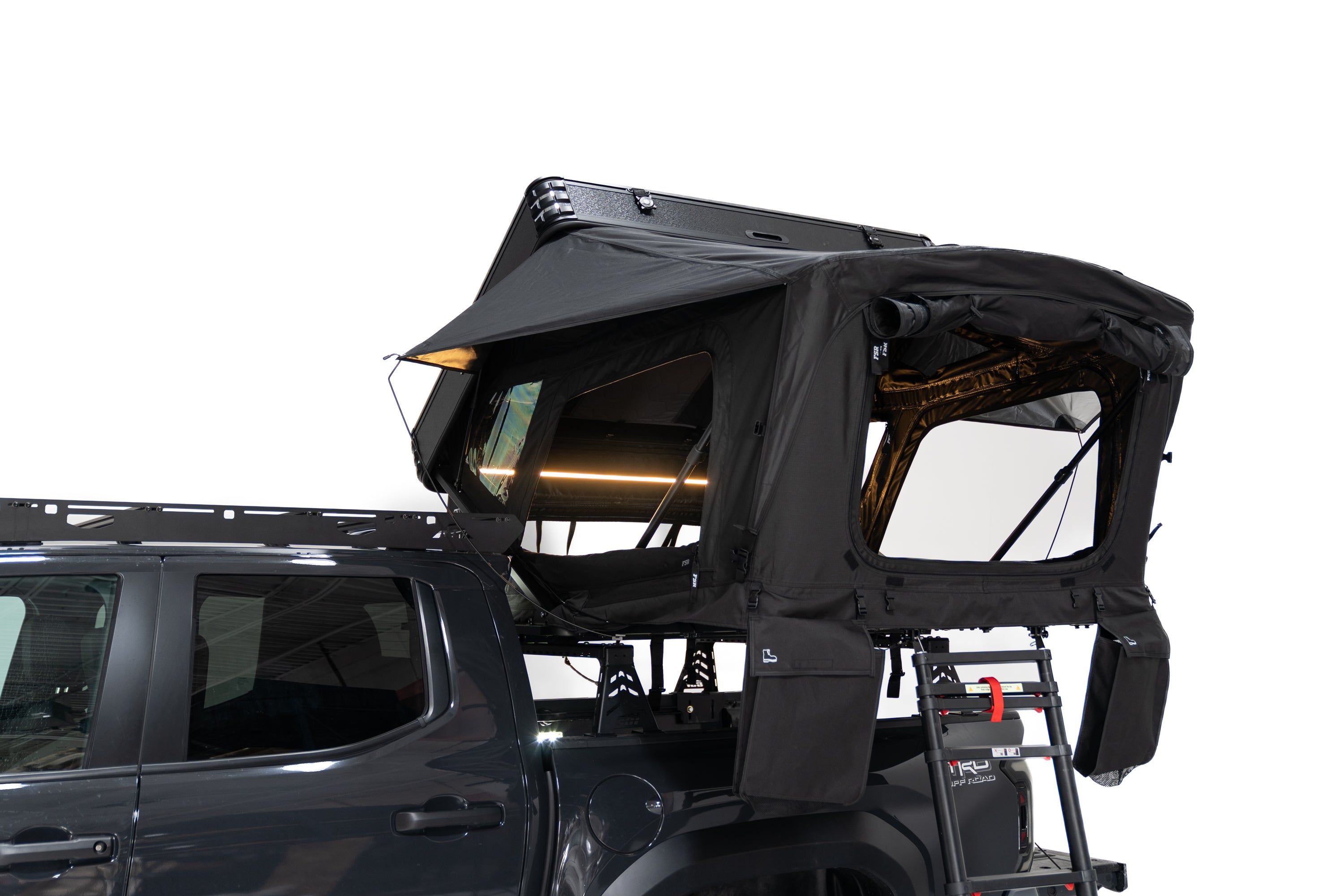Close up Exterior Photo of Kali hardshell rooftop tent by FSR - Deployed on the truck bed of a 4th gen Toyota Tacoma with dimmable lights on and windows open.