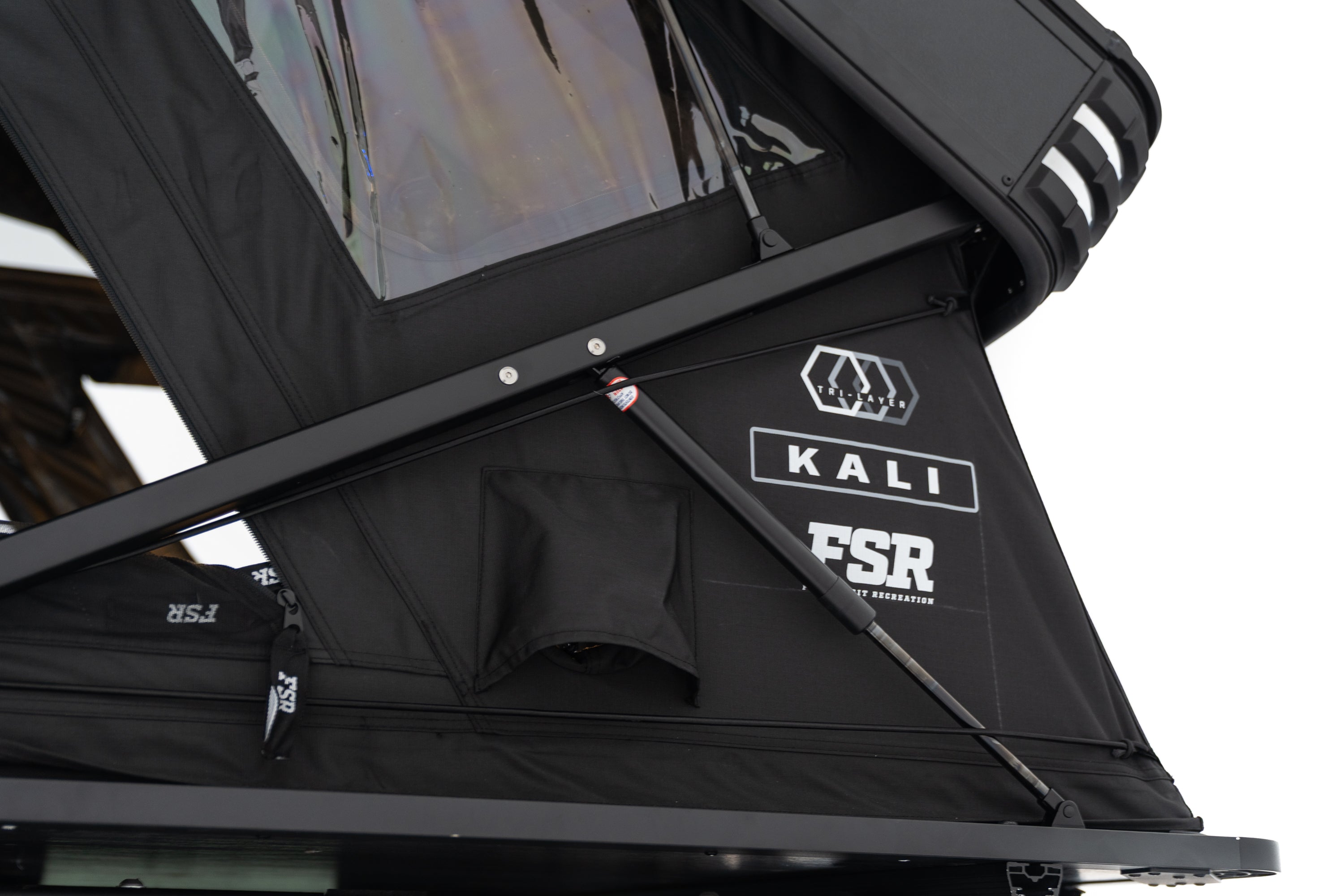 Close up Exterior Photo of Kali hardshell rooftop tent by FSR showing the branding and name of tent with the diesel heater ports.