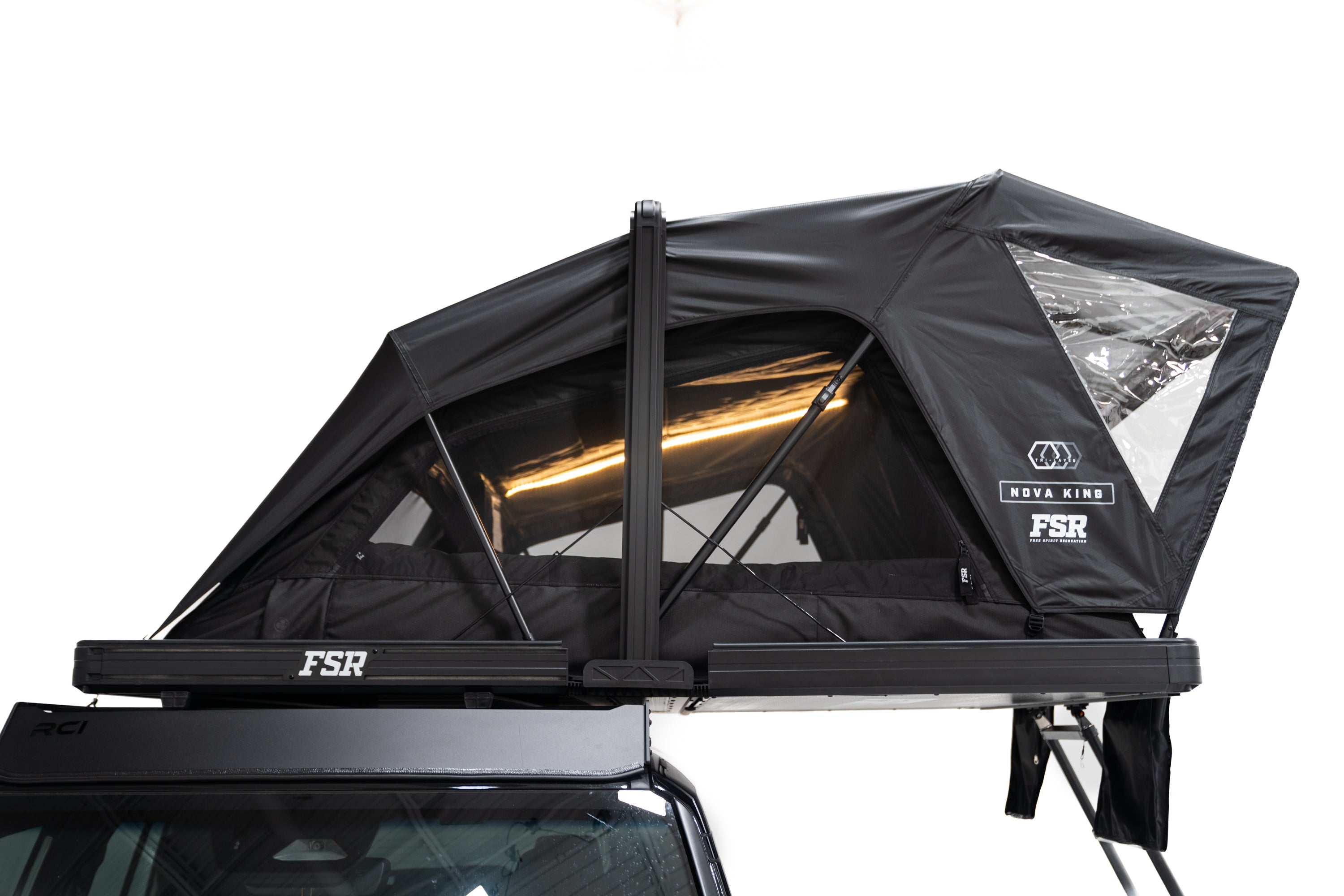 Side profile Close up Exterior photo of the Nova King rooftop tent mounted on a white Toyota land cruiser with the tent windows open and lights on.