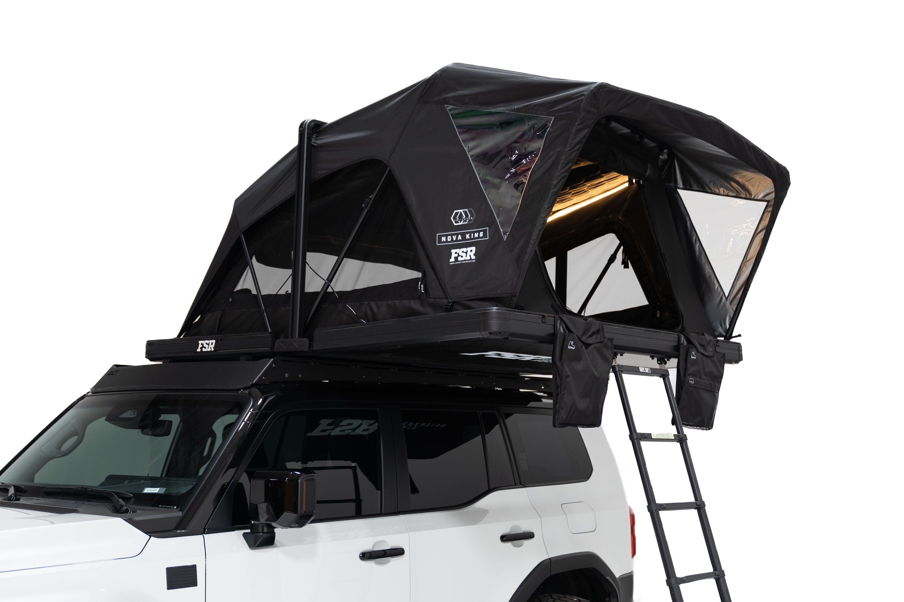 Close up Exterior photo of the Nova King rooftop tent mounted on a white Toyota land cruiser with the tent windows open and lights on.
