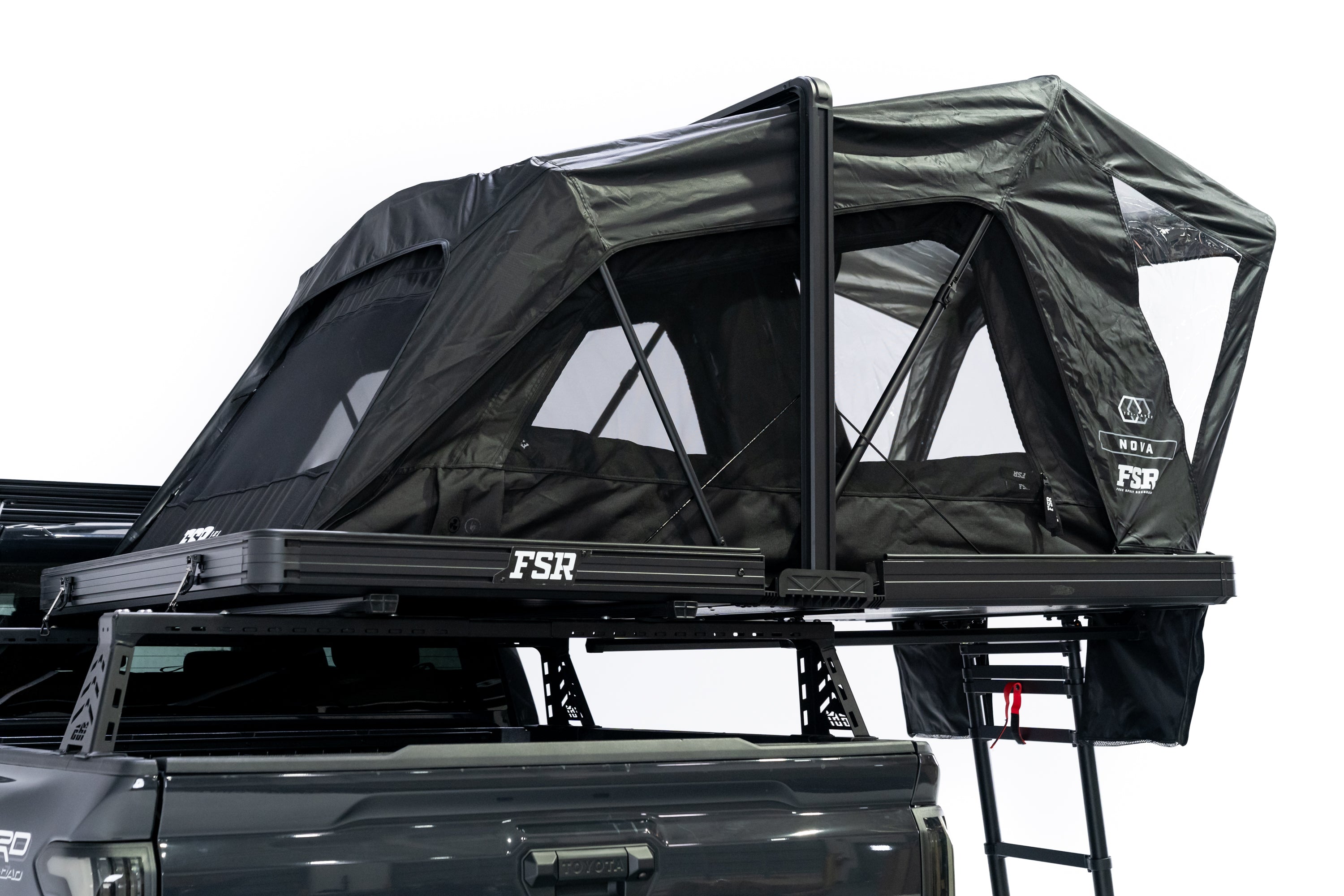 Photo of Nova Hybrid rooftop tent deployed on the rear of a 2025 Toyota Tacoma with he windows and doors open.