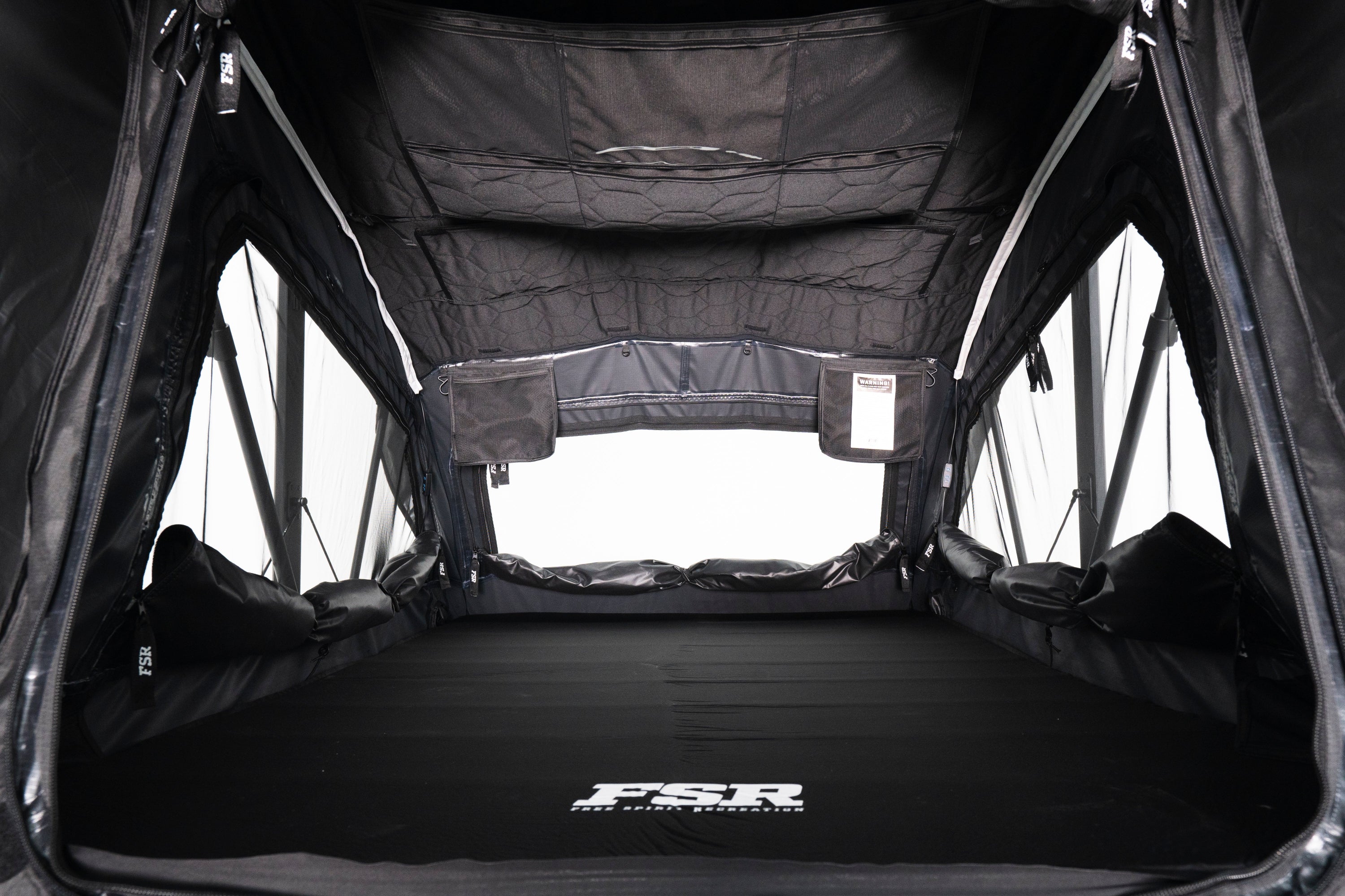 Interior Photo of Nova Hybrid rooftop tent deployed on the rear of a 2025 Toyota Tacoma without lights on.
