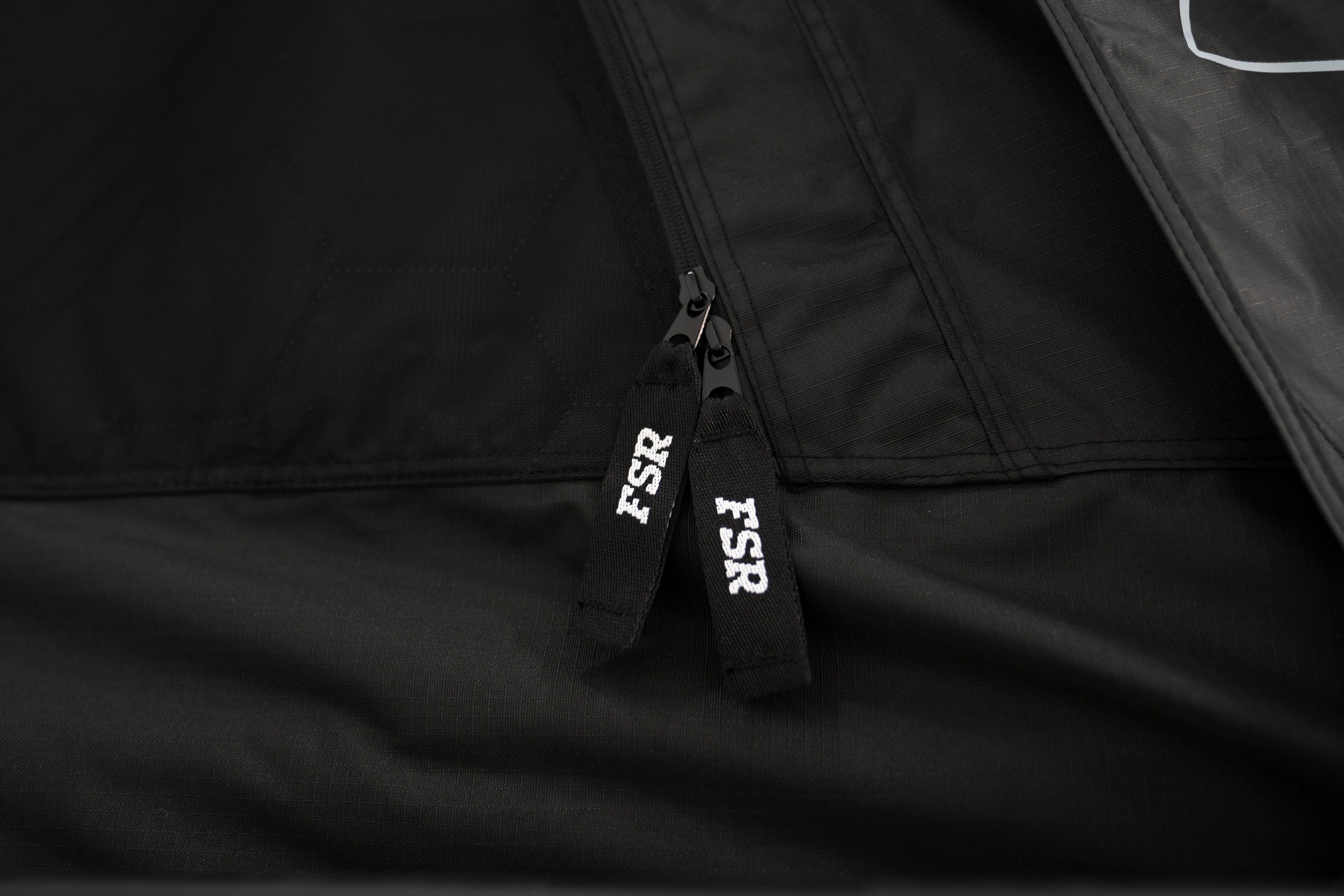 Up close photo of the FSR branded zippers on the FSR Nova rooftop tent.