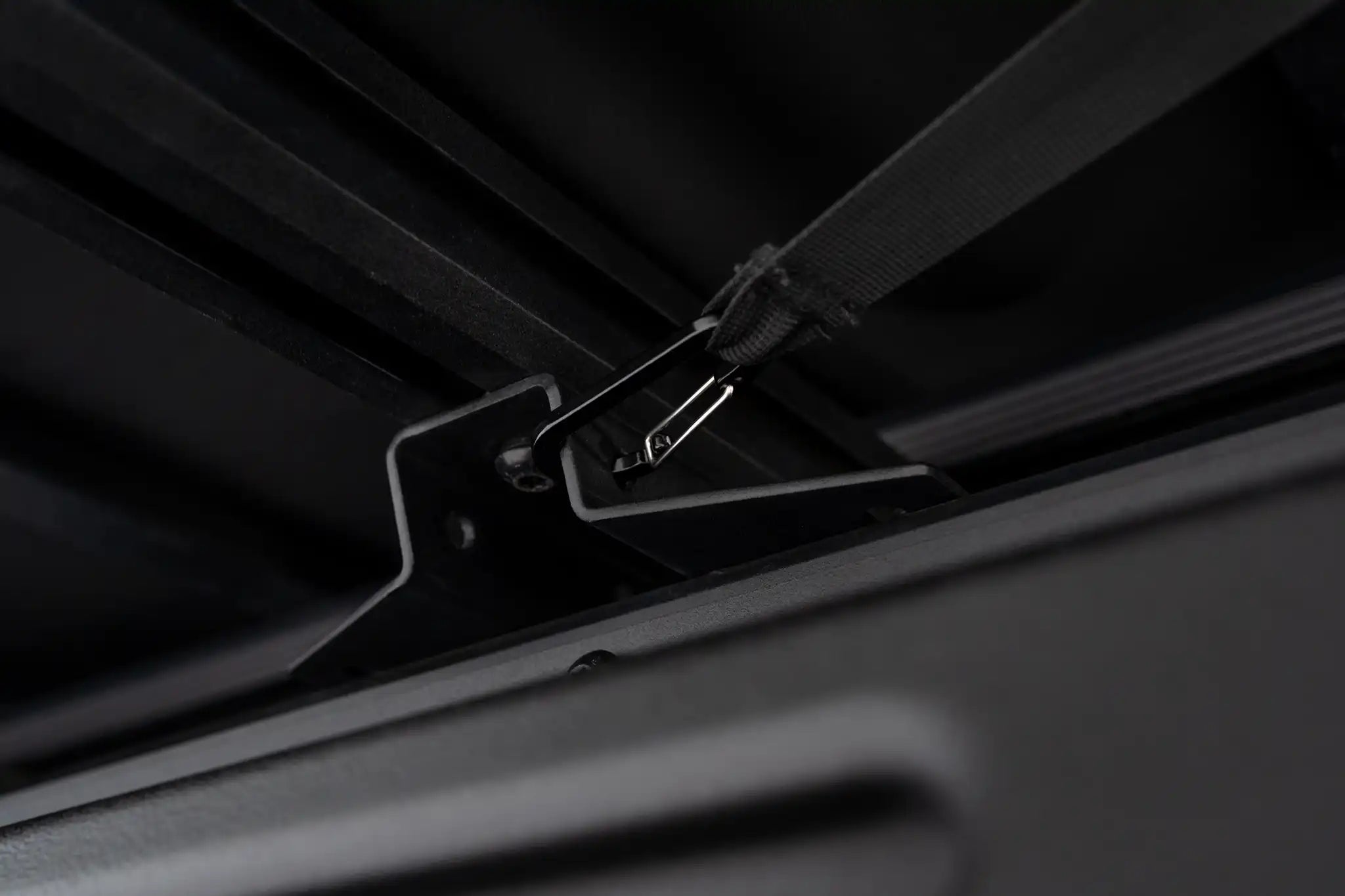 Up close photo of the carabiner tensioning system on the FSR 270 Awning by Freespirit Recreation secured to a vehicle's roof rack.