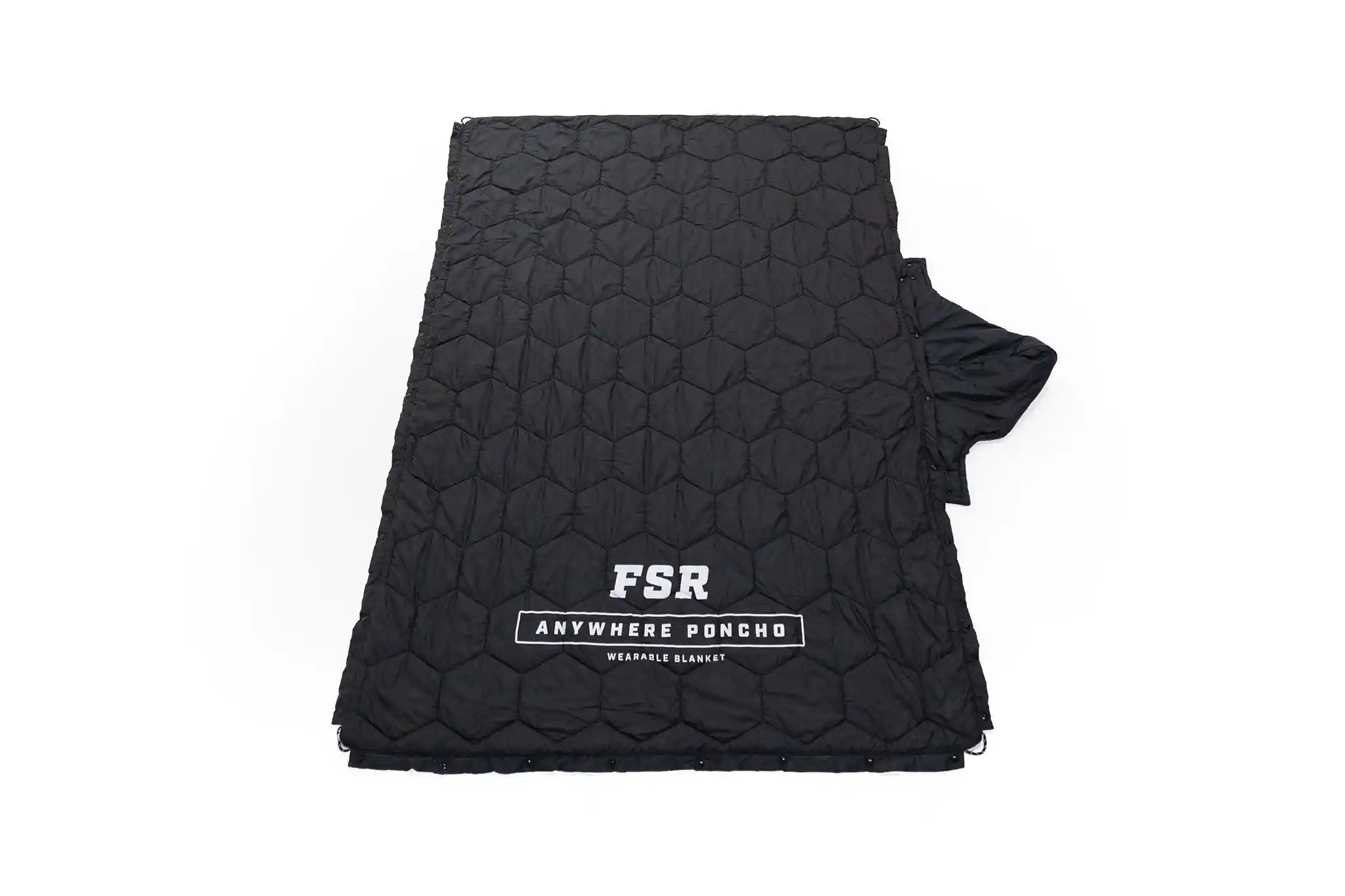 Black quilted outer shell of the FSR Anywhere Camping Poncho Blanket layed out flat