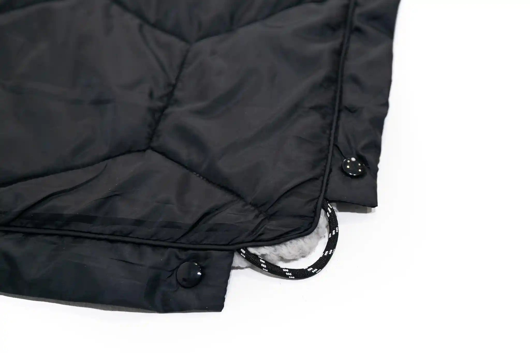 Close-up of the premium corner ties, fabrics, and button snaps on the FSR Anywhere Poncho Camping Blanket
