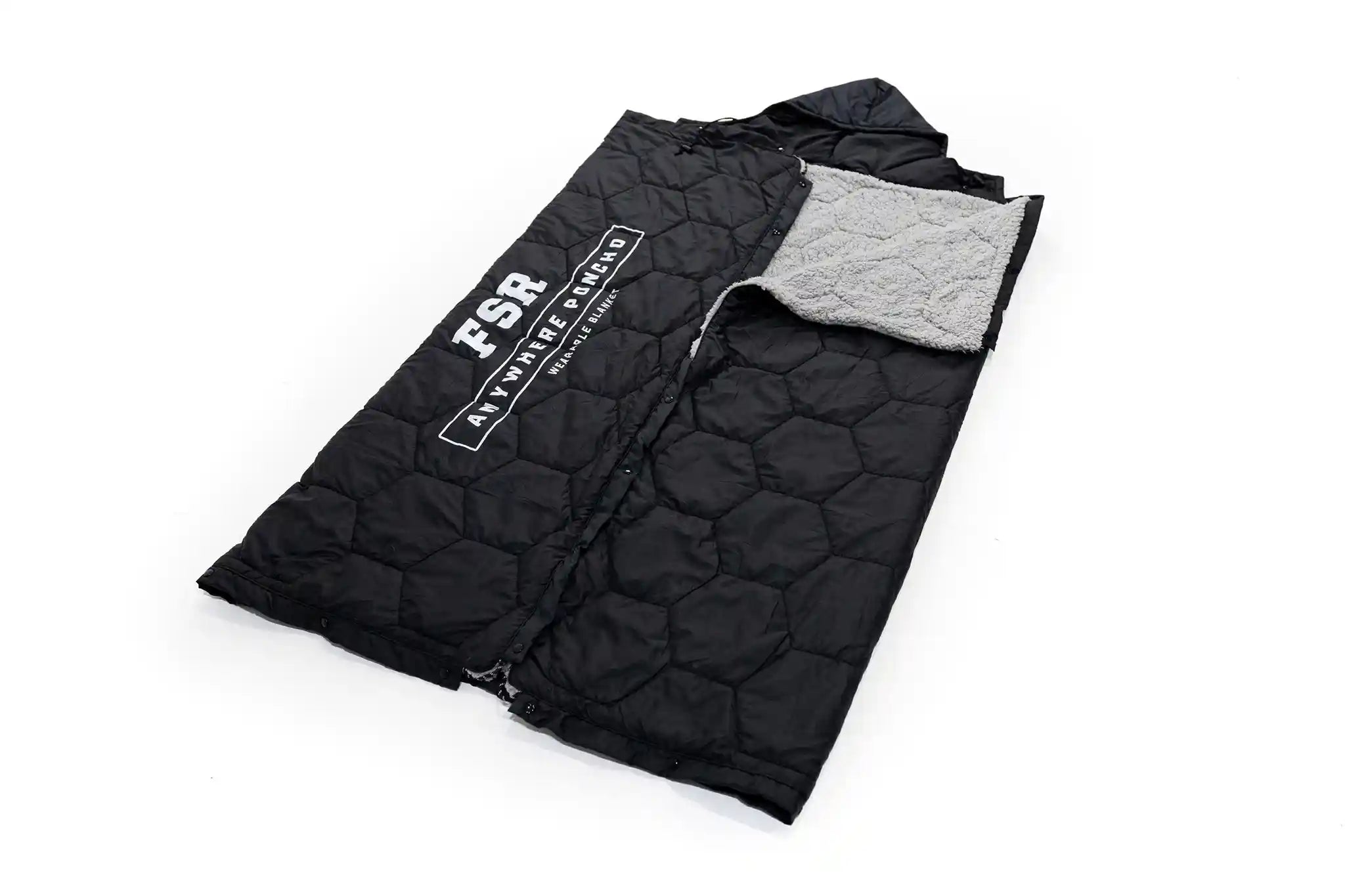 Black quilted FSR Anywhere Poncho Camping Blancket from Free Spirit Recreation with gray sherpa lining exposed on a white background