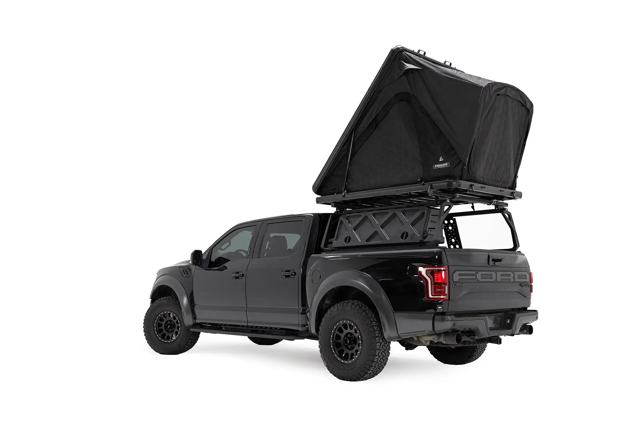 FSR Aspen Lite XL Rooftop Tent by Free Spirit Recreation deployed on a black Ford Raptor bed rack.