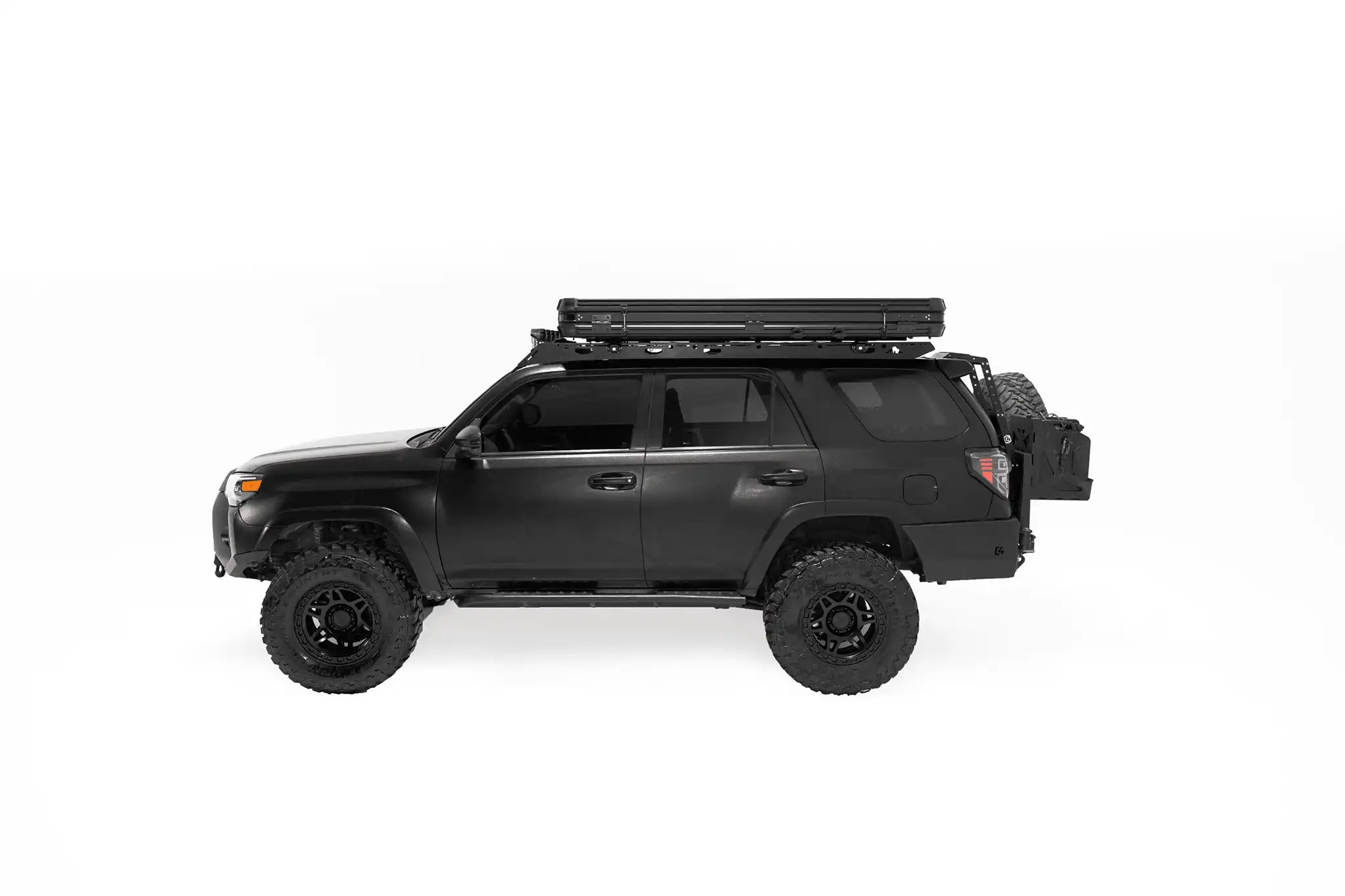 Side profile photo of a closed Evolution V2 Standard Rooftop Tent by Freespirit Recreation installed on a black Toyota 4Runner.