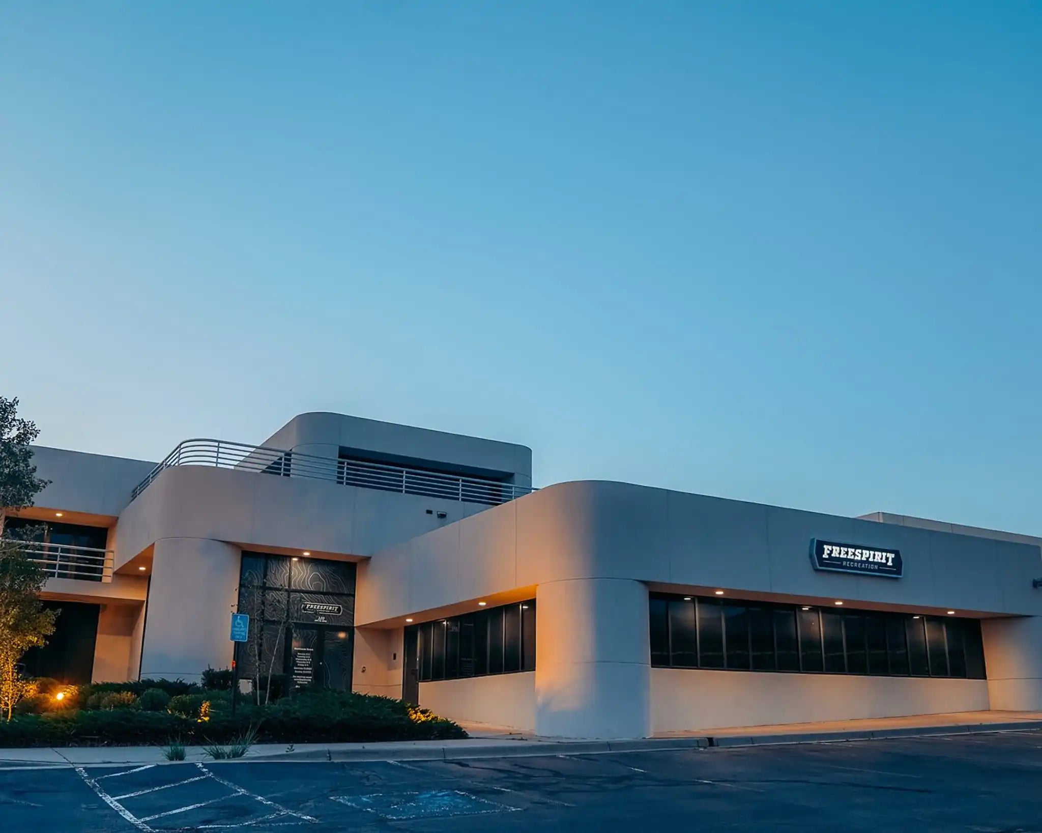 Image of the front of the 2022 Free Spirit Recreation headquarters building in Boulder Colorado with a clear blue sky in the background at dawn