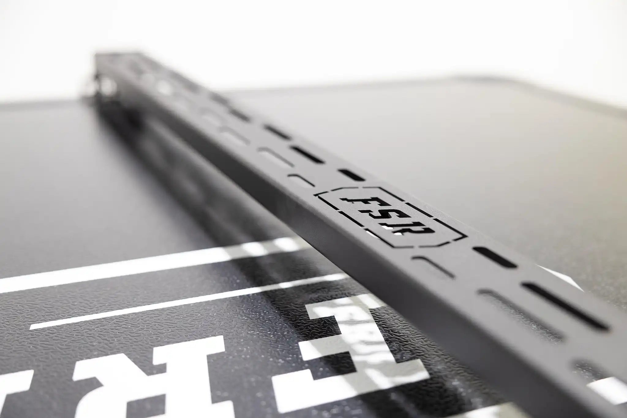 Close up of an FSR Crossbar for hard shell roof top tents from Free Spirit Recreation showing the universal mounting slots in the top of the cross bars for securing cargo to the RTT load bars