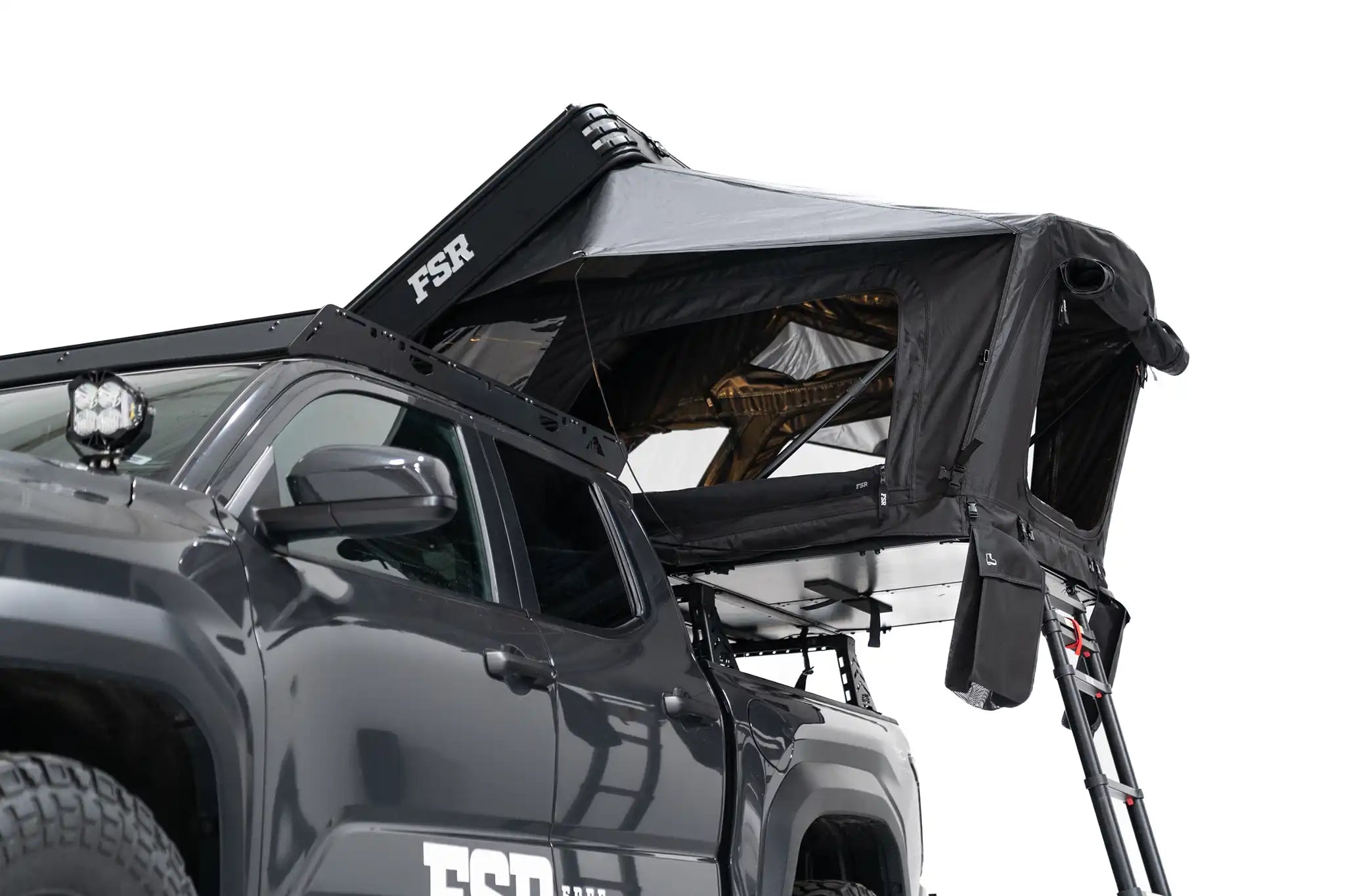 Lower exterior photo showing the bottom of the FSR Kali hardshell rooftop tent deployed on the truck bed of a 4th gen Toyota Tacoma.