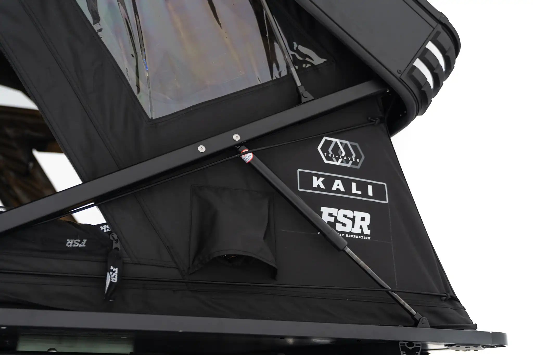 Close-up exterior photo of the FSR Kali hardshell rooftop tent showing the branding and the built-in diesel heater ports