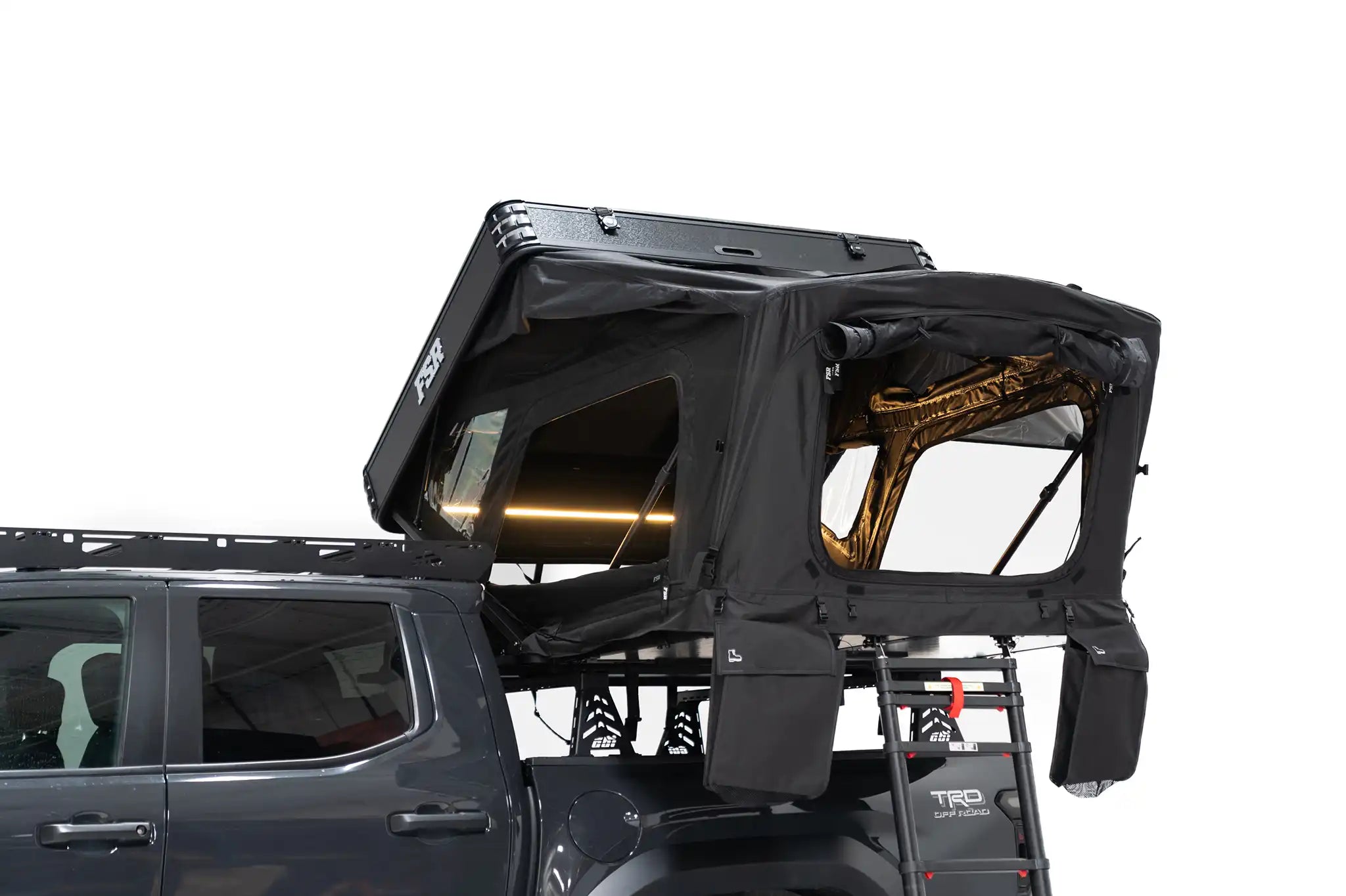 Exterior Photo of Kali hardshell rooftop tent by FSR - Deployed on the truck bed of a 4th gen Toyota Tacoma with the interior LED lights on and the windows open.