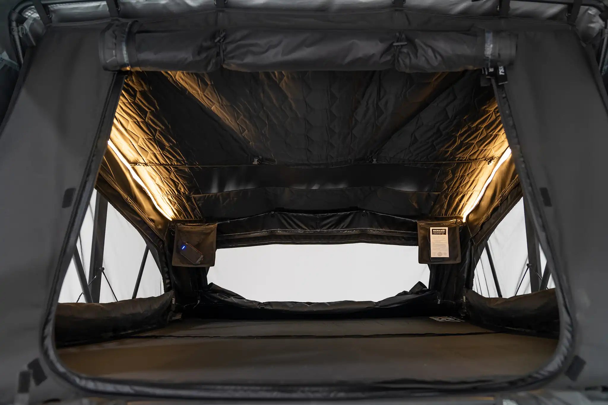 Close-up photo of the FSR Nova King rooftop tent interior with the lights on.