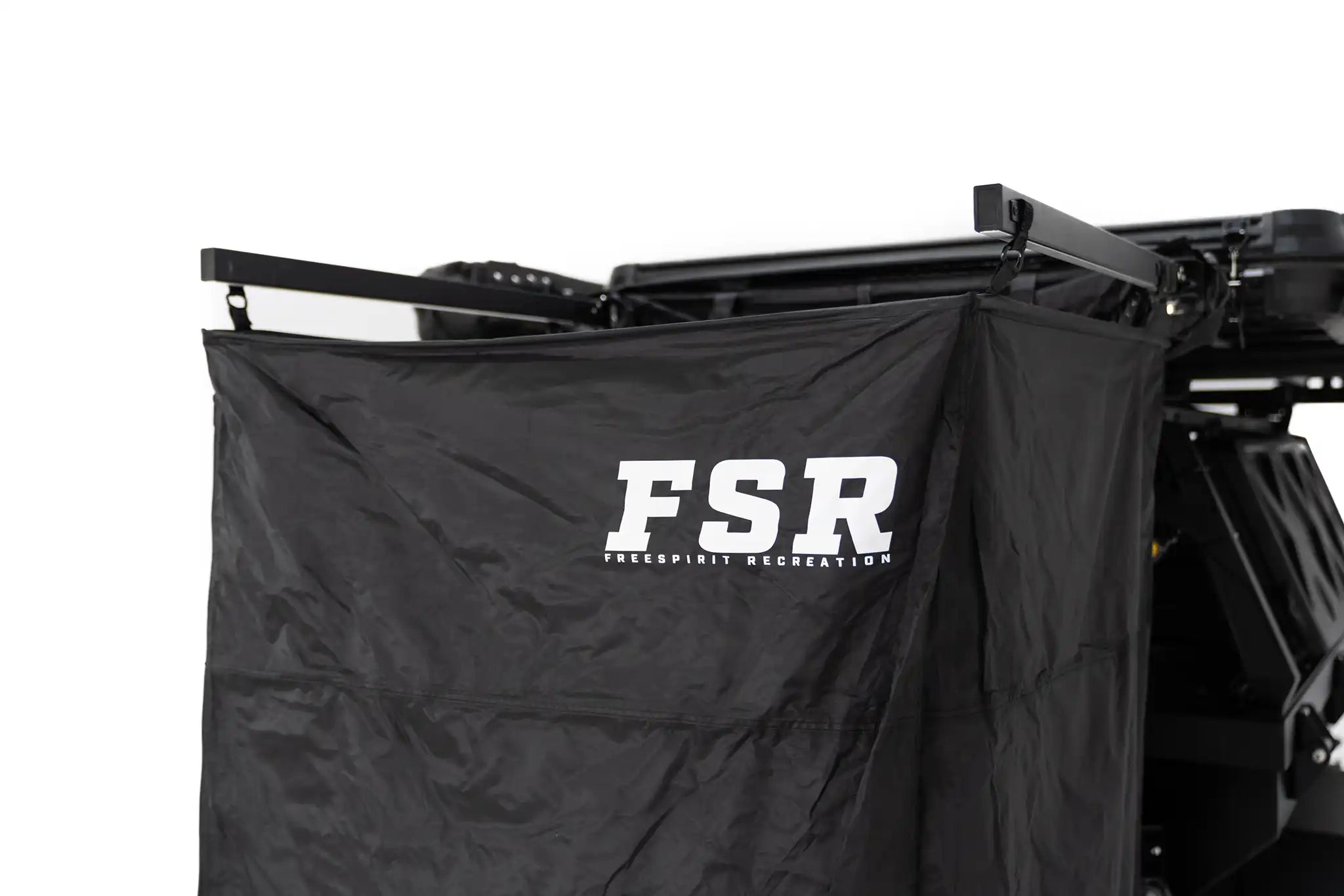 Close up image of the FSR Shower Awning curtain with Freespirit Recreation branding visible mounted to a roof top tent for use as a camping shower and bathroom tent