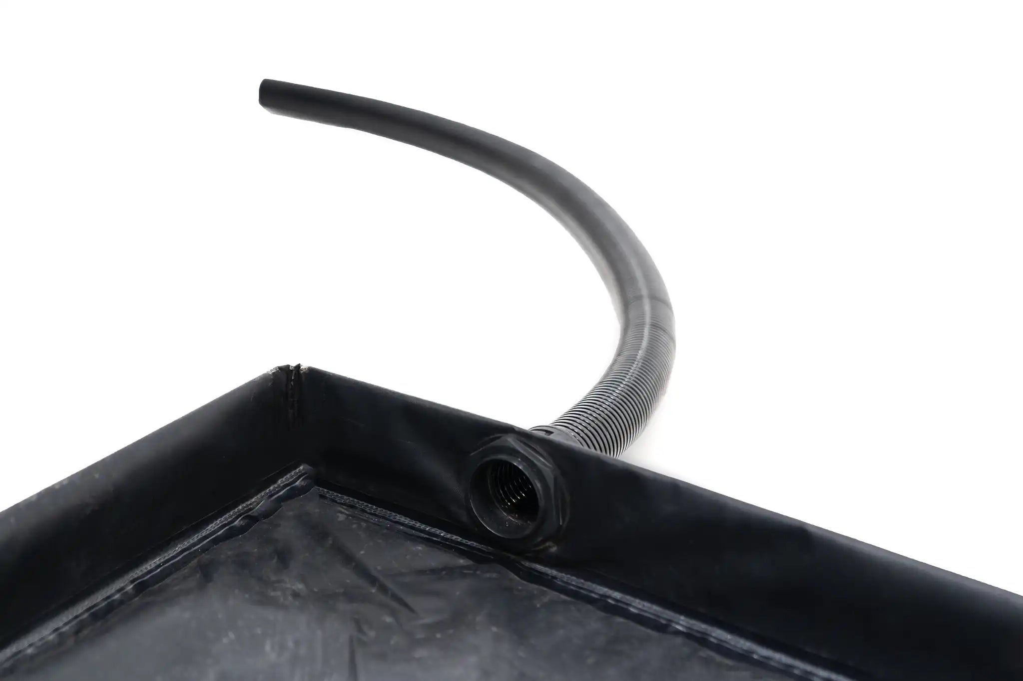 Close up image of the FSR Shower Awning removable floor pan interior with drain hose connected