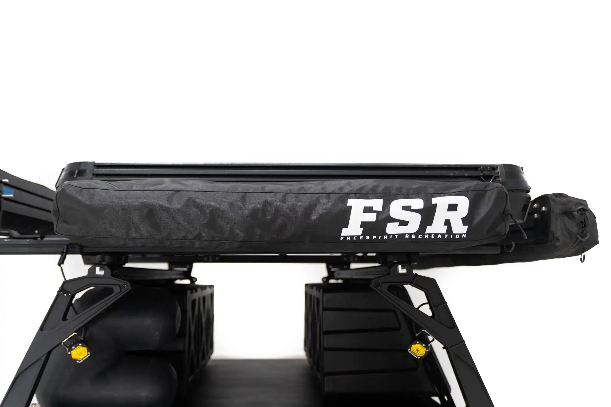 Image of the FSR Shower Awning from Freespirit Recreation, mounted to a Freespirit Recreation Roof Top Tent installed on an overland trailer, closed and packed in zippered storage bag