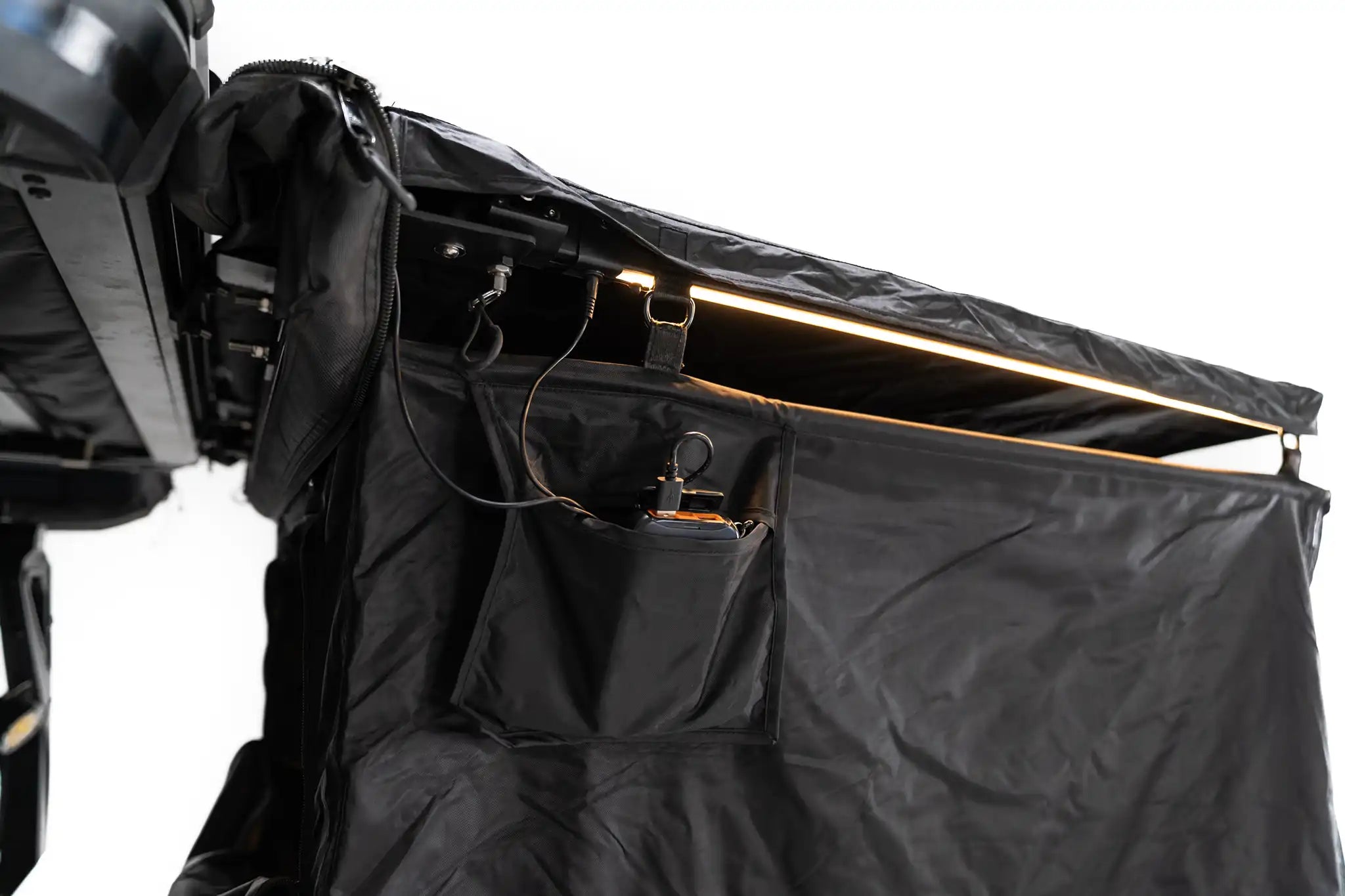 Close up image of the FSR Shower Awning LED light illuminated with battery pack stored in the exterior pocket