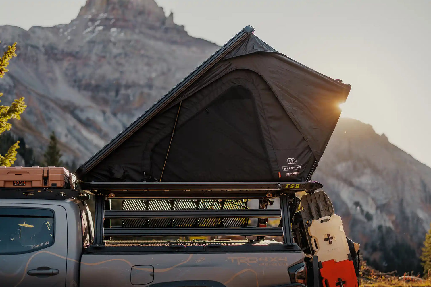 FSR Truck Bed Tent setup on the bed rack of a Toyota Tacoma with a scenic mountain sunset in the background