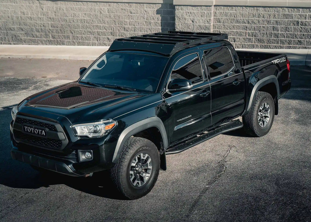 Backwoods Adventure Mods 2005-2023 2nd and 3rd Gen Toyota Tacoma DRIFTR Roof Rack cargo carrier installed on a black Tacoma