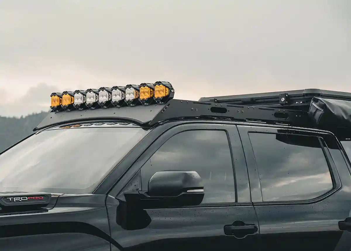 Image of Toyota Tundra 3rd Gen (2022+) DRIFTR Roof Rack by Backwoods Adventure Mods with off road lights mounted over the wind fairing | Free Spirit Recreation