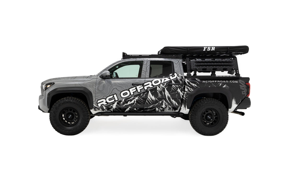 Side profile photo of RCI Toyota Tacoma with FSR Aspen V2 standard rooftop tent mounted on the bed of the short bed pickup with the cover on. 