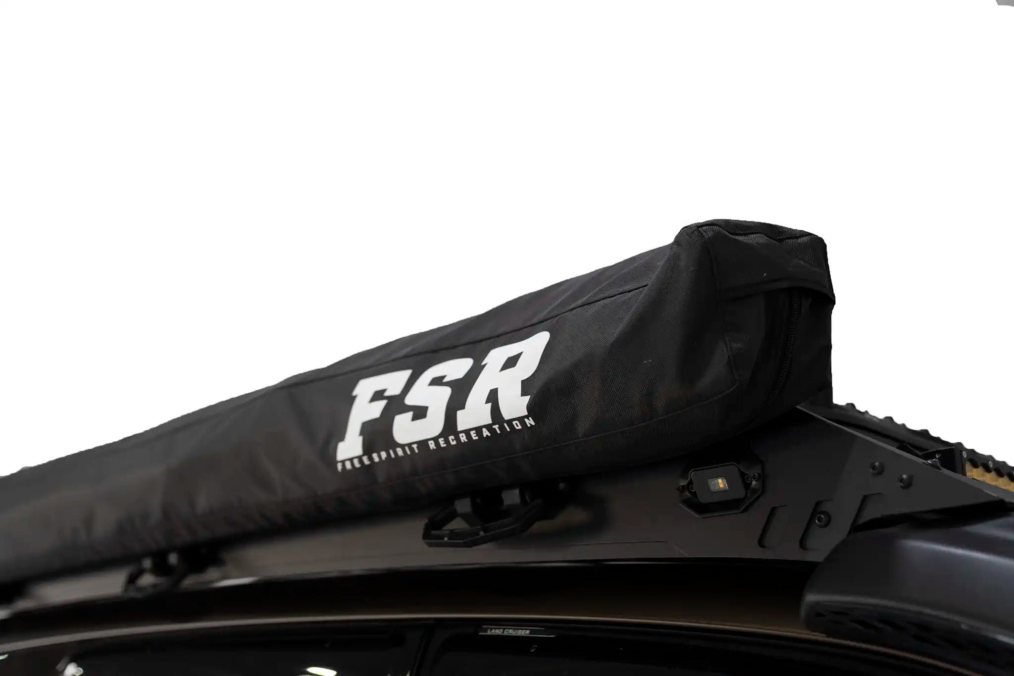 Close up photo of the stowed FSR 180 Degree Car Awning from Freespirit Recreation mounted on a overland 4wd vehicle roof rack for camping