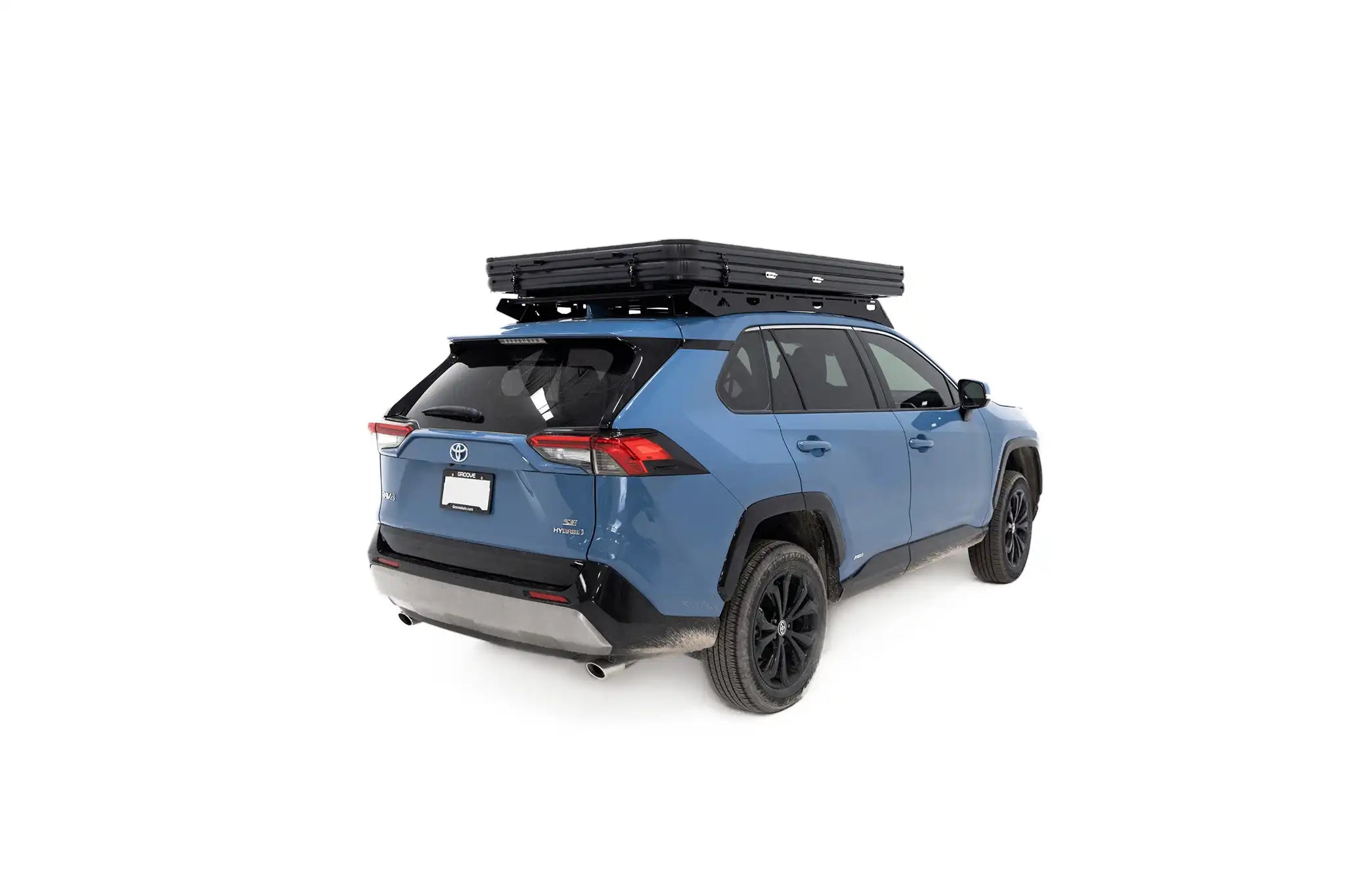 Rear angle photo of the installed FSR Aspen Lite Standard Rooftop Tent in its closed position mounted on a blue Toyota Rav4. 