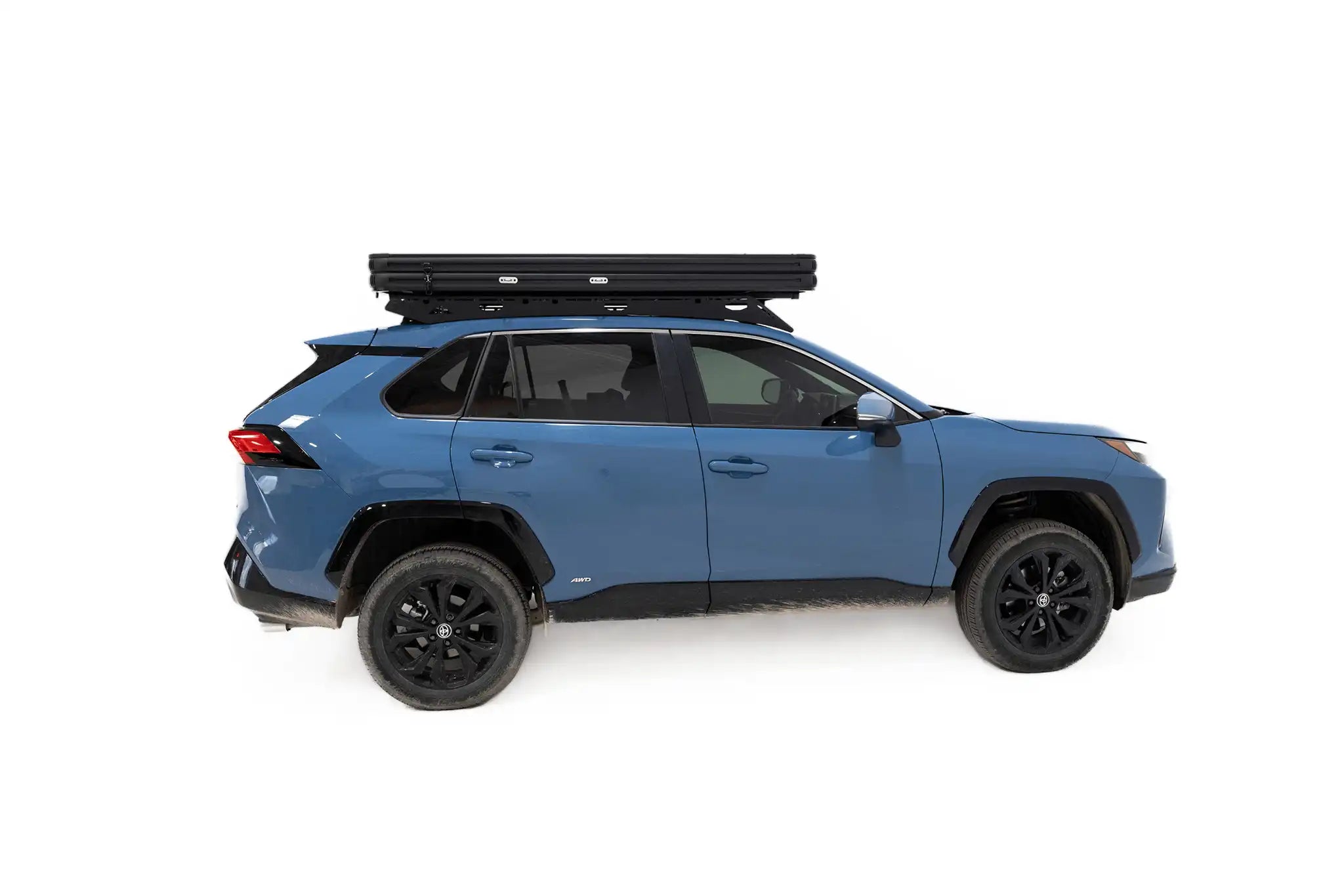 Side profile photo of the FSR Aspen Lite Standard Rooftop Tent when closed and mounted on a blue Toyota Rav4.