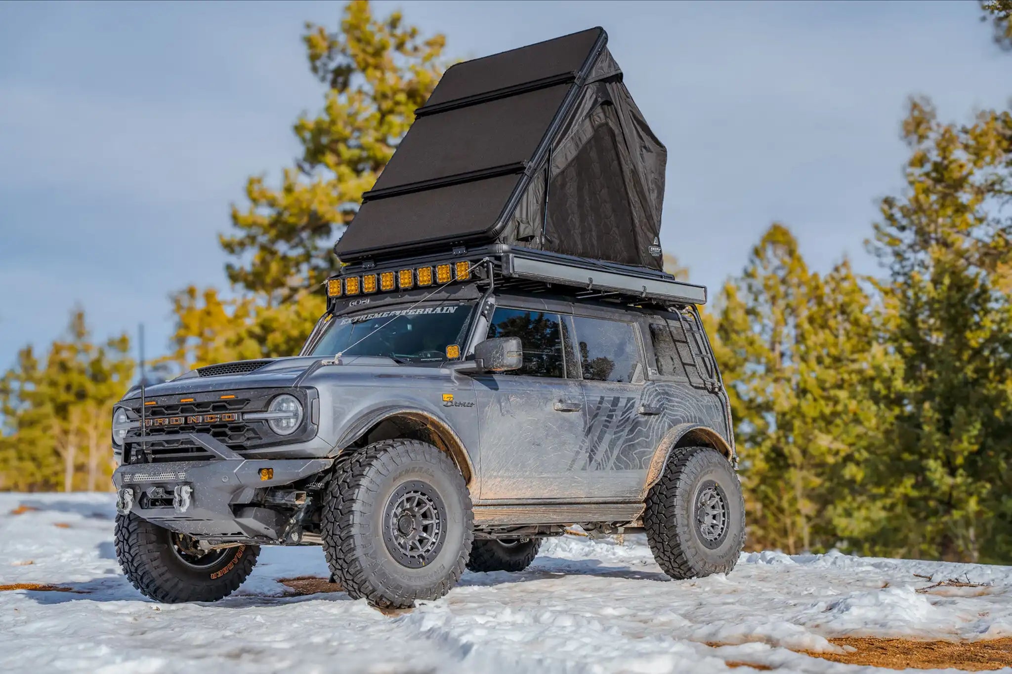 Exterior photo of the FSR Aspen Lite XL Rooftop Tent showing the included crossbars for cargo storage and mounting. 