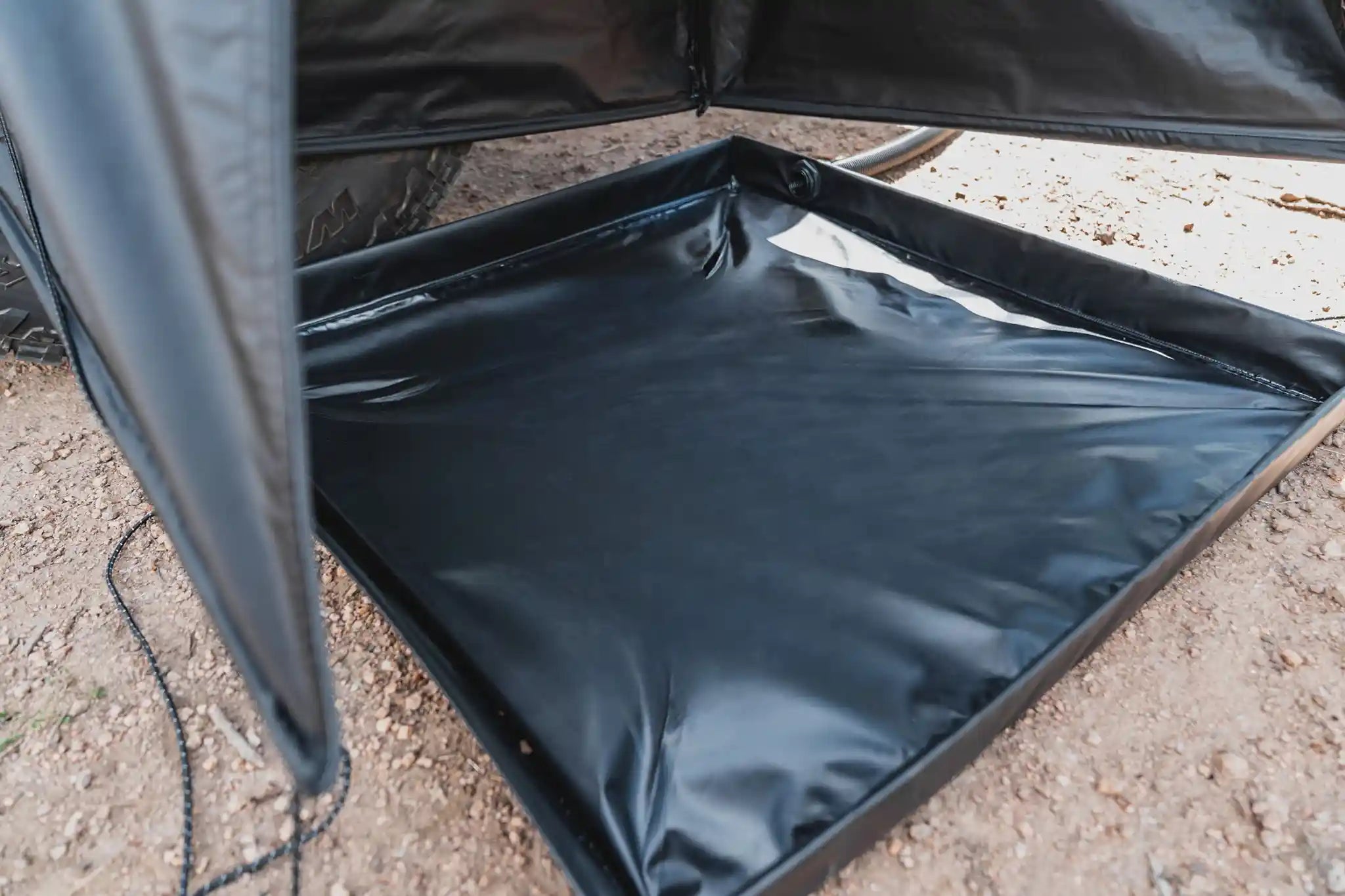 Close-up image of the removable floor tray included with the FSR Shower Awning for camping and overlanding setups