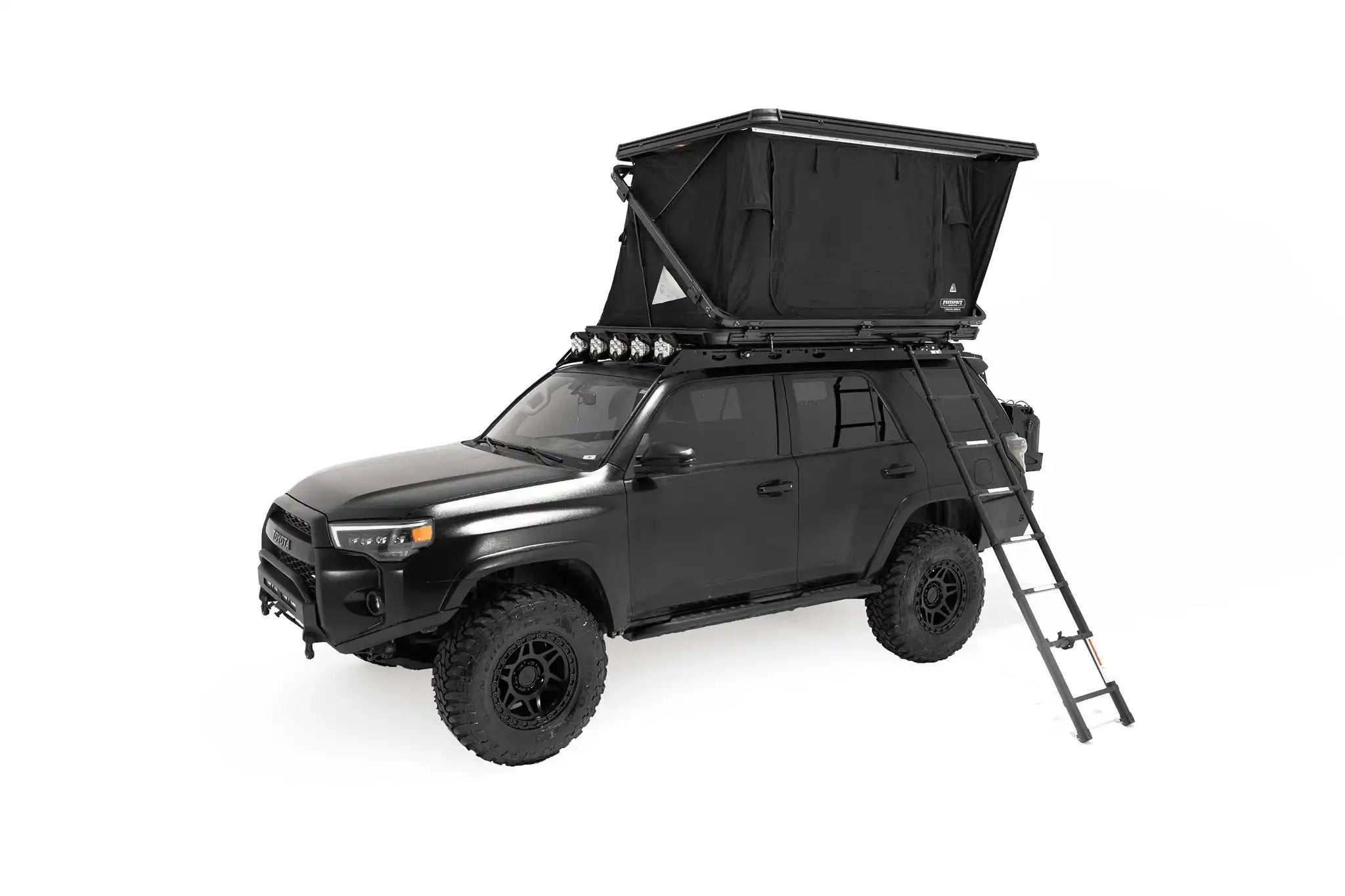 FSR Evolution V2 Standard Rooftop Tent by Freespirit Recreation installed on the roof rack of a black Toyota 4Runner with tent deployed and ladder installed