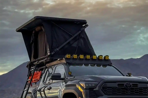 Toyota tacoma with an FSR Evo XL rooftop tent setup on the bed rack against a mountainous landscape