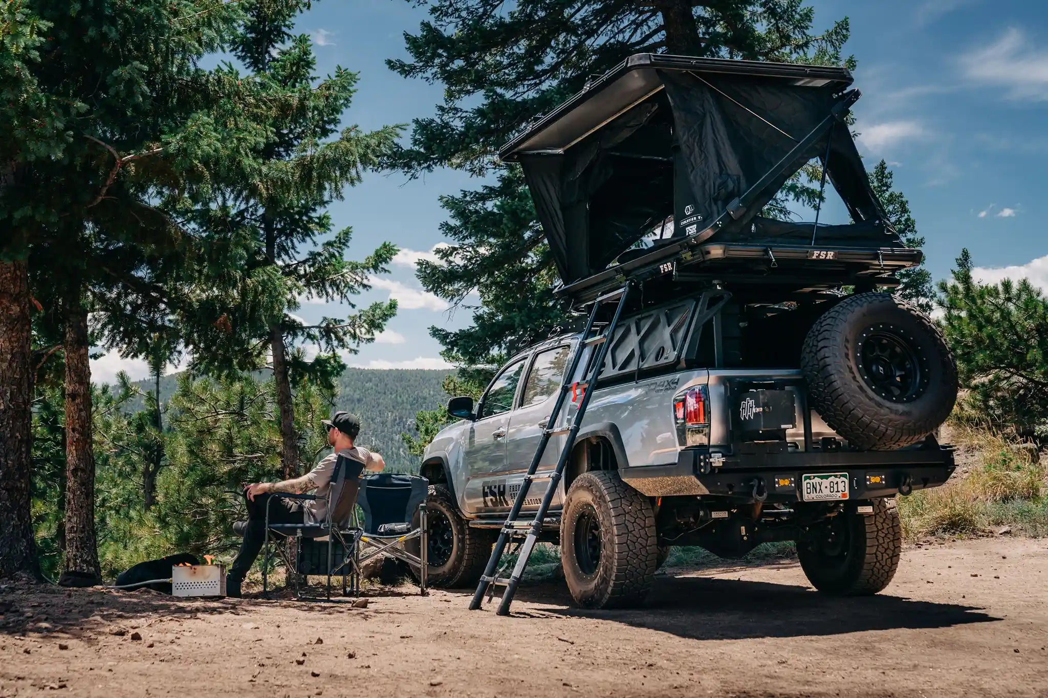 FSR Evolution V3 XL hardshell rooftop tent deployed on truck at scenic overlanding campsite